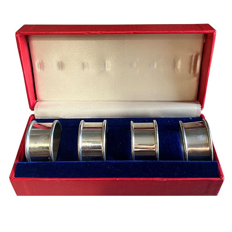 A large set of vintage pewter napkin rings. This is a set of 12 pieces, (4 in each box). Each ring is round and features a small lip around each end and is stamped with the word 
