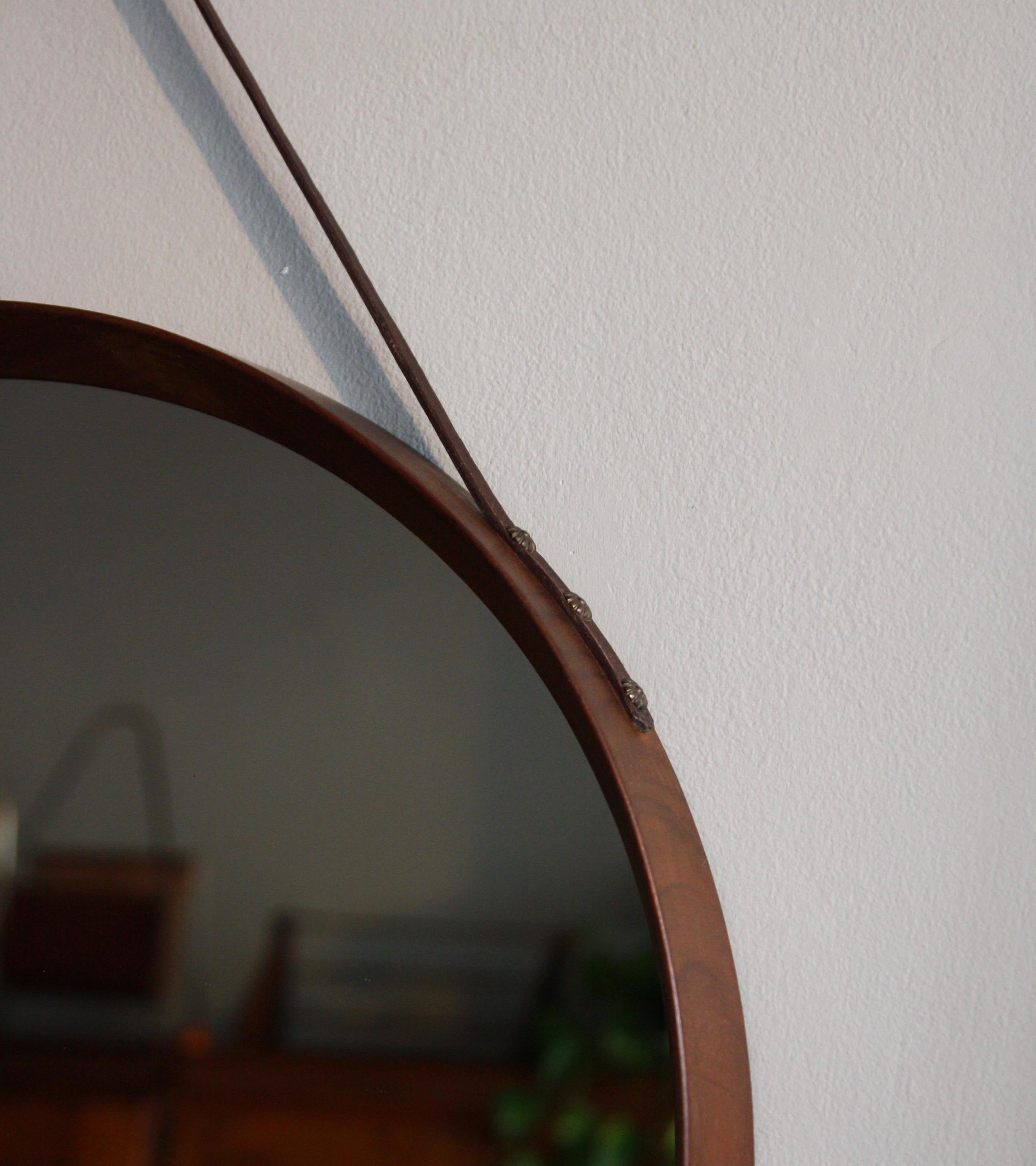 round mirror with leather hanging strap