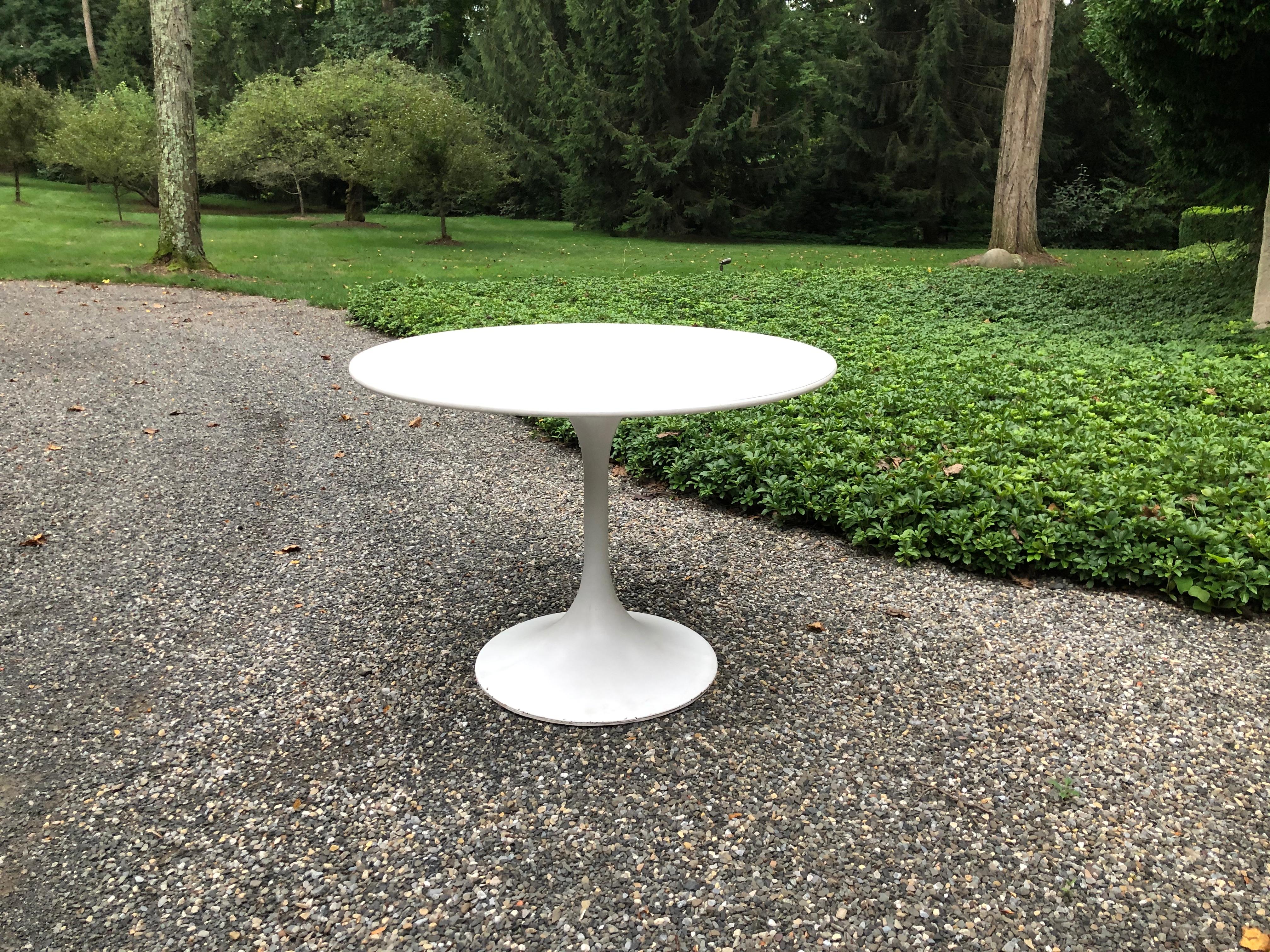 Vintage “Tulip” dining table  having an aluminum base and laminate top. Wear consistent with age and use. 