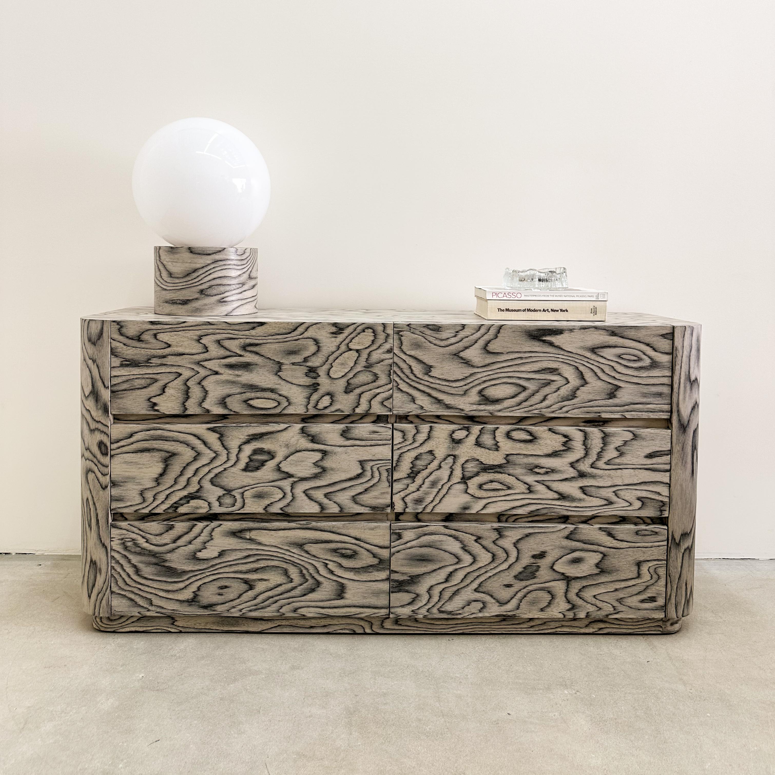 This vintage dresser features re-veneering with the original ALPI veneer, designed by Ettore Sottsass in 1985 an iconic figure in the Memphis design movement. Its distinctive veneer has been sealed with a satin finish to enhance durability. 