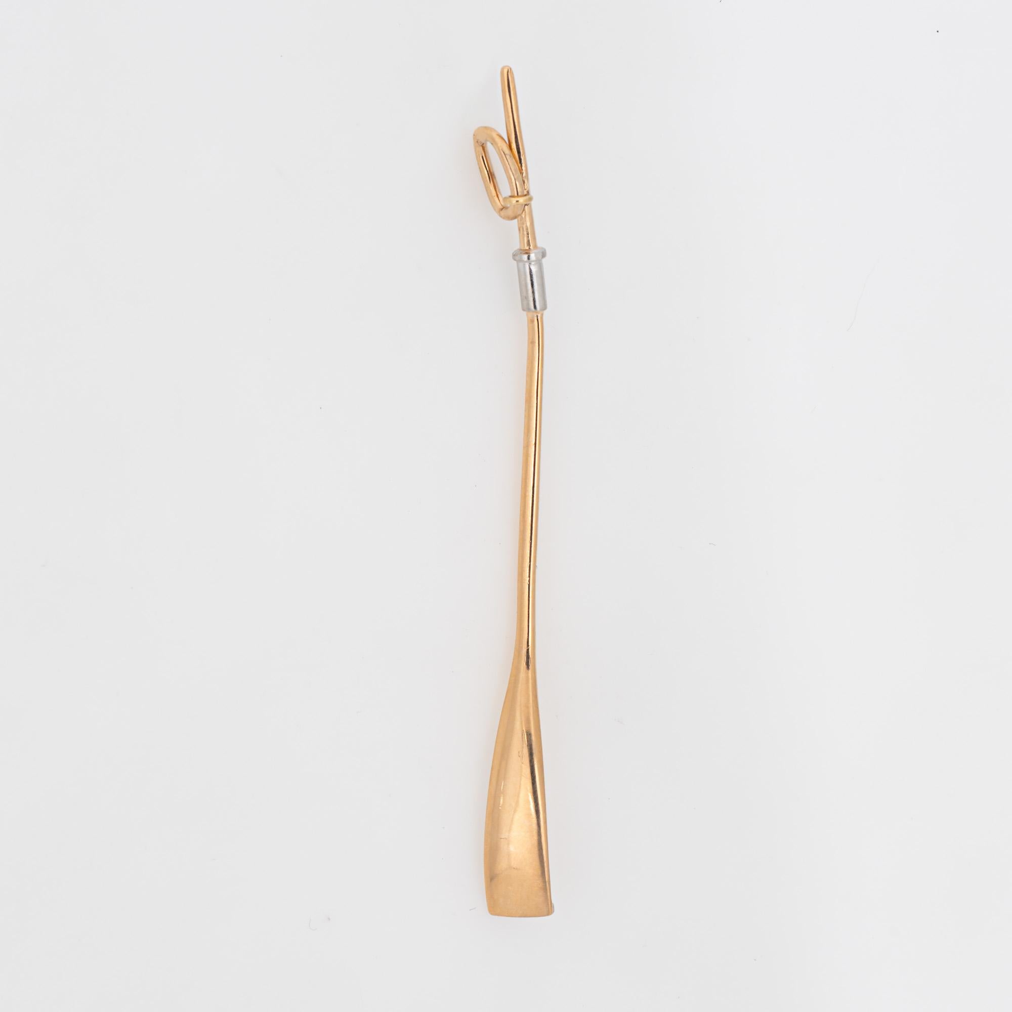 Finely detailed vintage rowing oar crafted in 14k yellow gold.  

Originally a stick pin, we converted the oar to a pendant (a bale was added). The piece can be worn as a charm on a bracelet or as a pendant on a necklace.  

Particulars:

Weight: