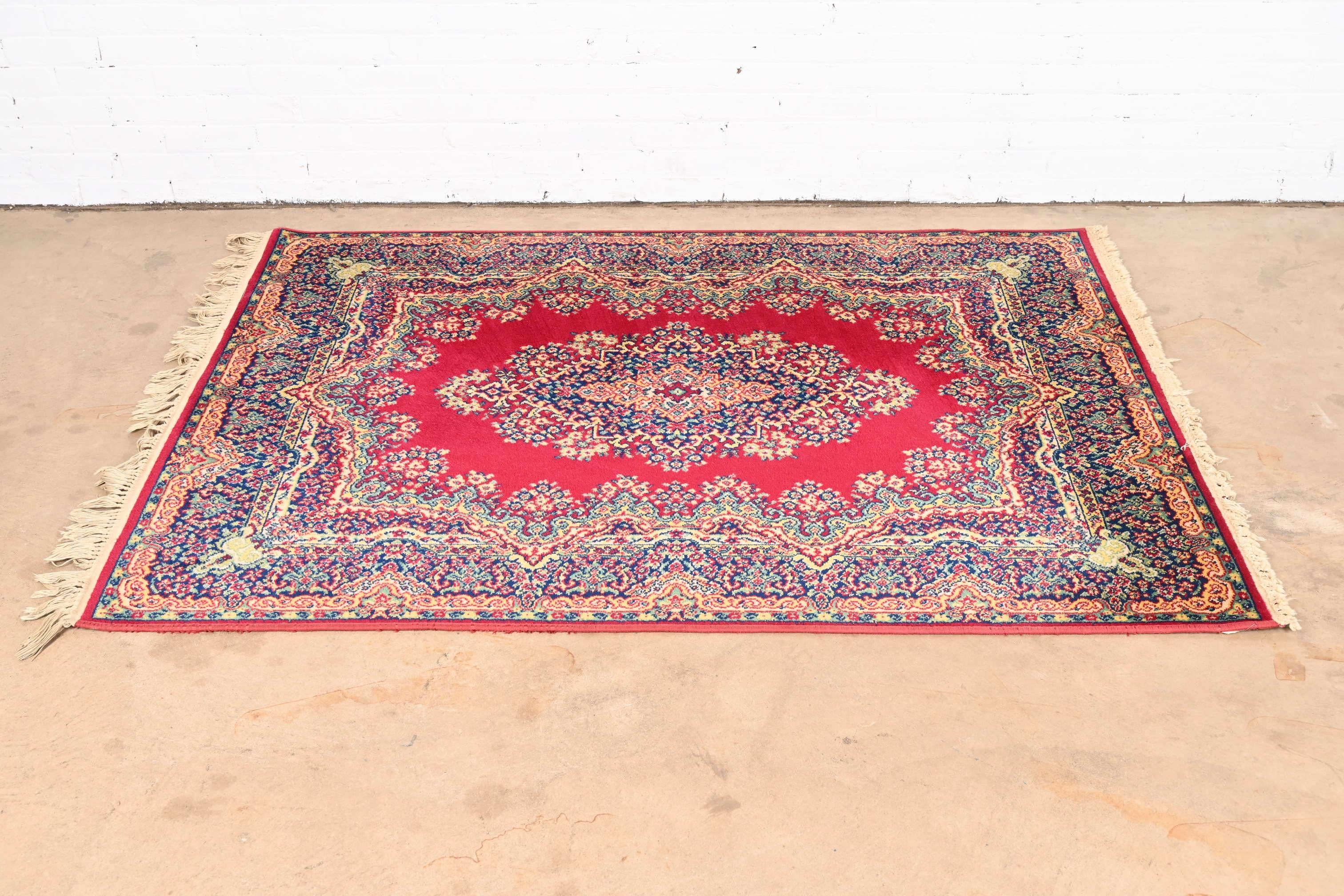 A gorgeous Royal Ashan Oriental style wool area rug

USA, mid-20th century

Beautiful floral design, with predominant colors in red, blue, and gold.

Measures: 55