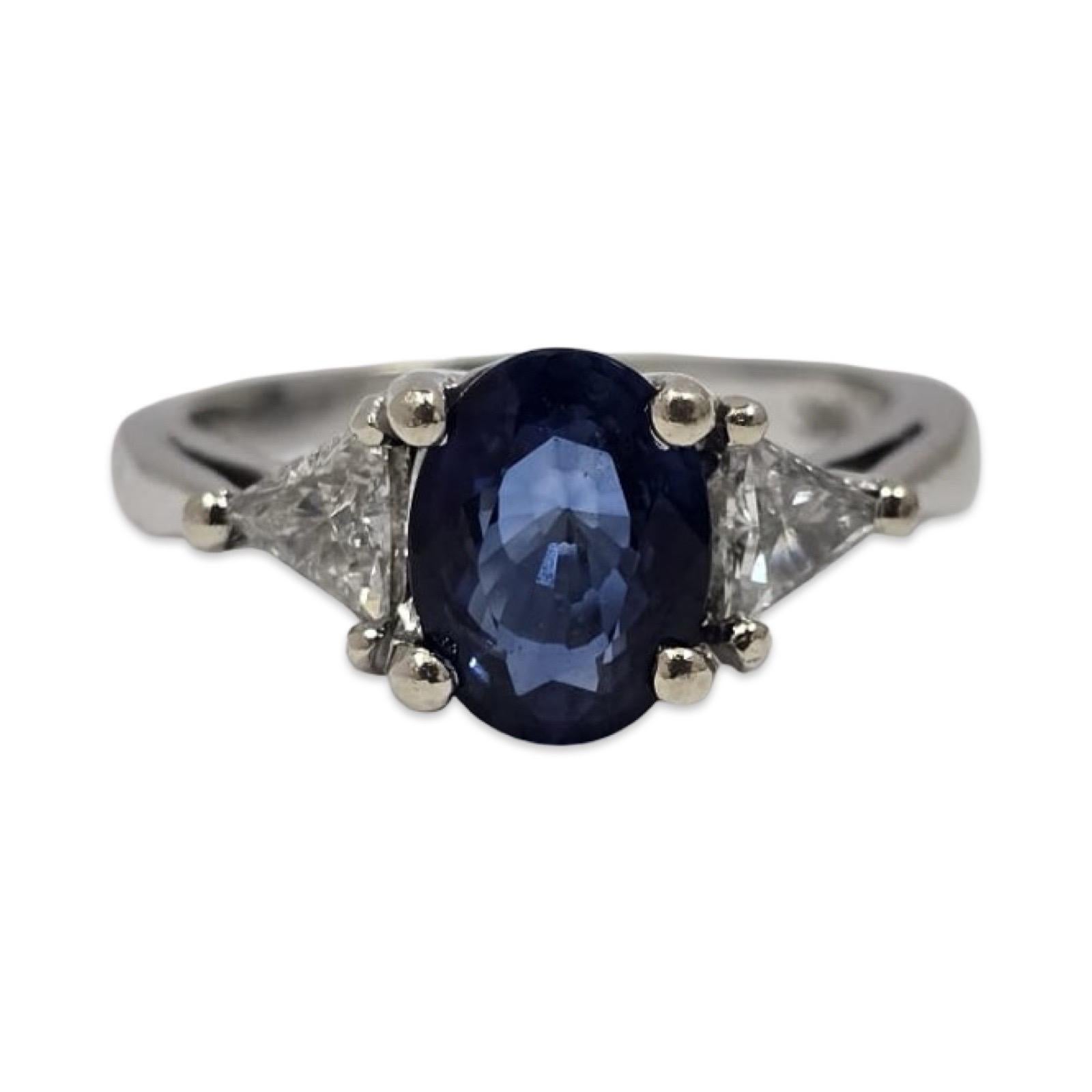 Vintage three-stone sapphire and diamond ring featuring ~2.40 total carats of fine gemstones set in solid 14K white gold. The centerpiece is a vivid ~1.80ct oval royal-blue sapphire measuring approximately 8.5 × 6.4mm, showing rich color and lively
