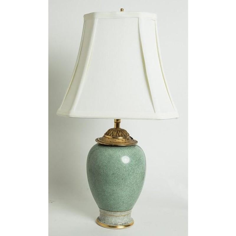 Gorgeous table lamp made from a repurposed porcelain vase by Royal Copenhagen. Beautiful crazing finish, or 'craquelure', to the seafoam green and white glaze of the vase. Gold rim at the base. Lamp neck is decorated with an ornate leaf gilded