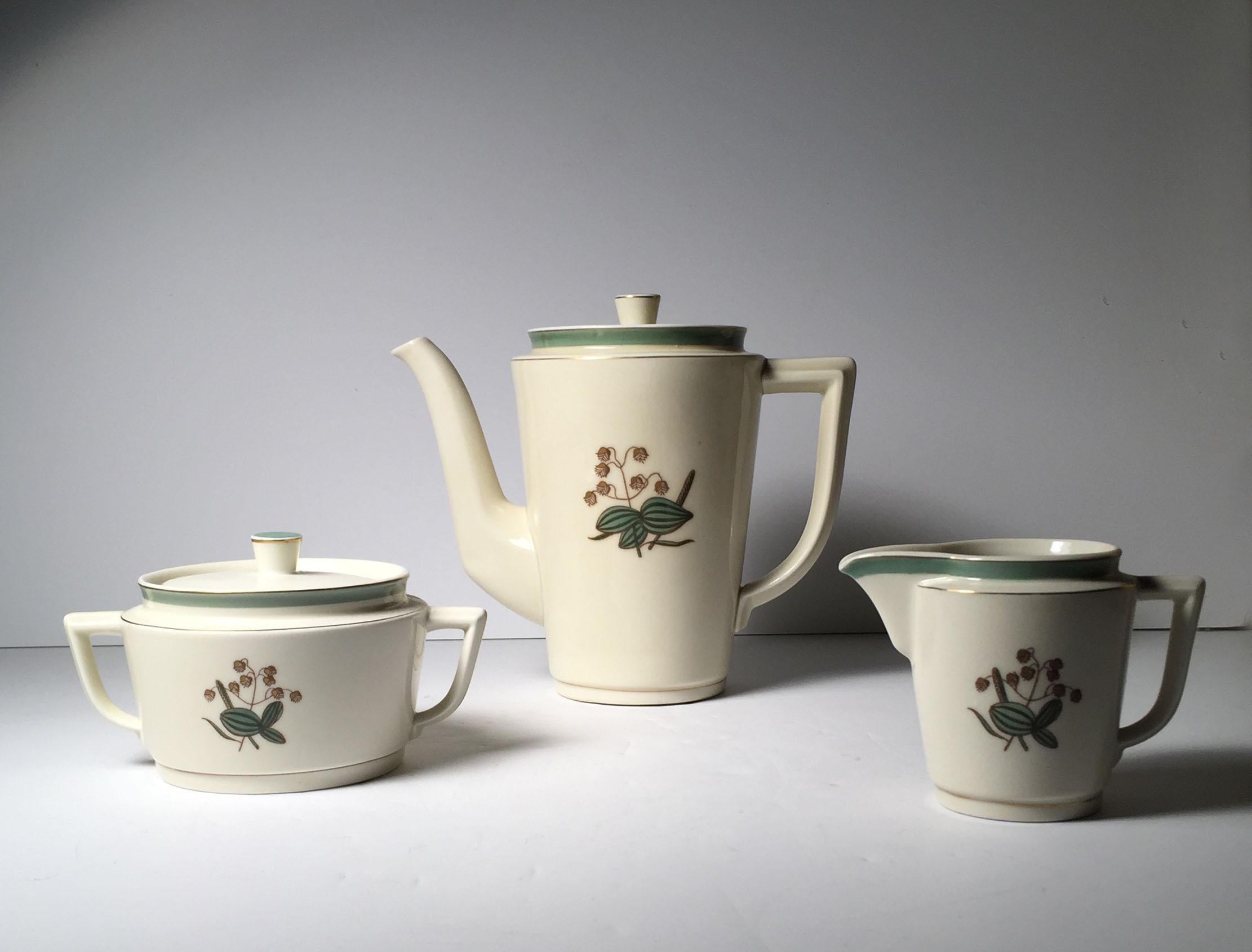 A fine vintage Danish porcelain set. Pieces Signed on underside. Service of eight with small cake plates. All with artistic decoration to the porcelain. Porcelain is a ivory color (has a warmth yellowish off-white color)

Coffee or teapot
Sugar