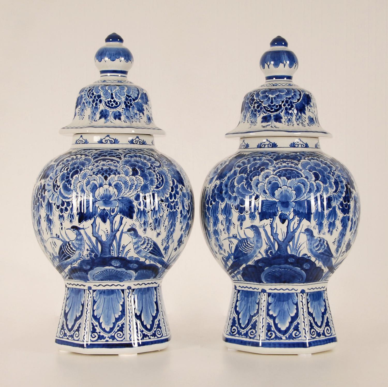 A pair Dutch Delftware Royal Delft vases - Urns.
Tall decorative covered baluster vases on an octagonal foot.
The vases are hand crafted and hand painted in enchanting blue colors, blue camaieu.
Floral decoration with peacock birds
Origin The