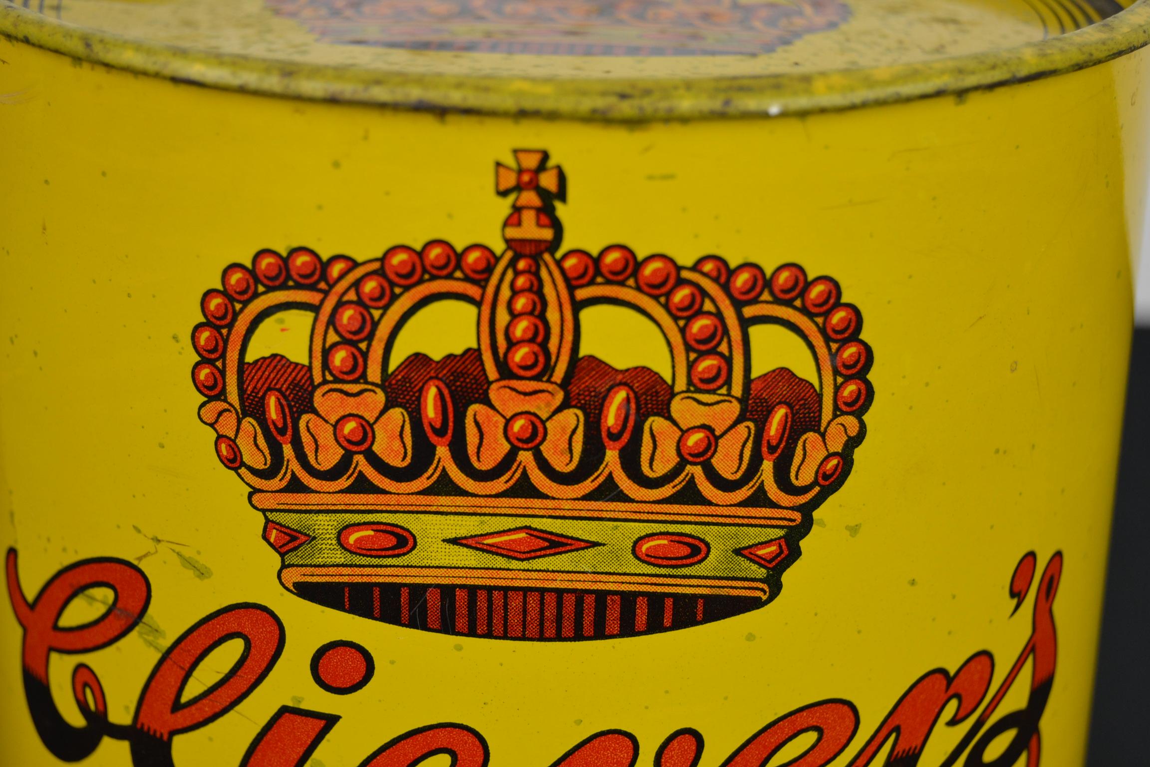 Vintage toffee tin with a royal crown. 
This yellow tin dates from the 1960s and has a 5 pointed red royal crown and beautiful lettering. 
It was designed for the Dutch toffee brand Clievers which was located in Rotterdam, The Netherlands