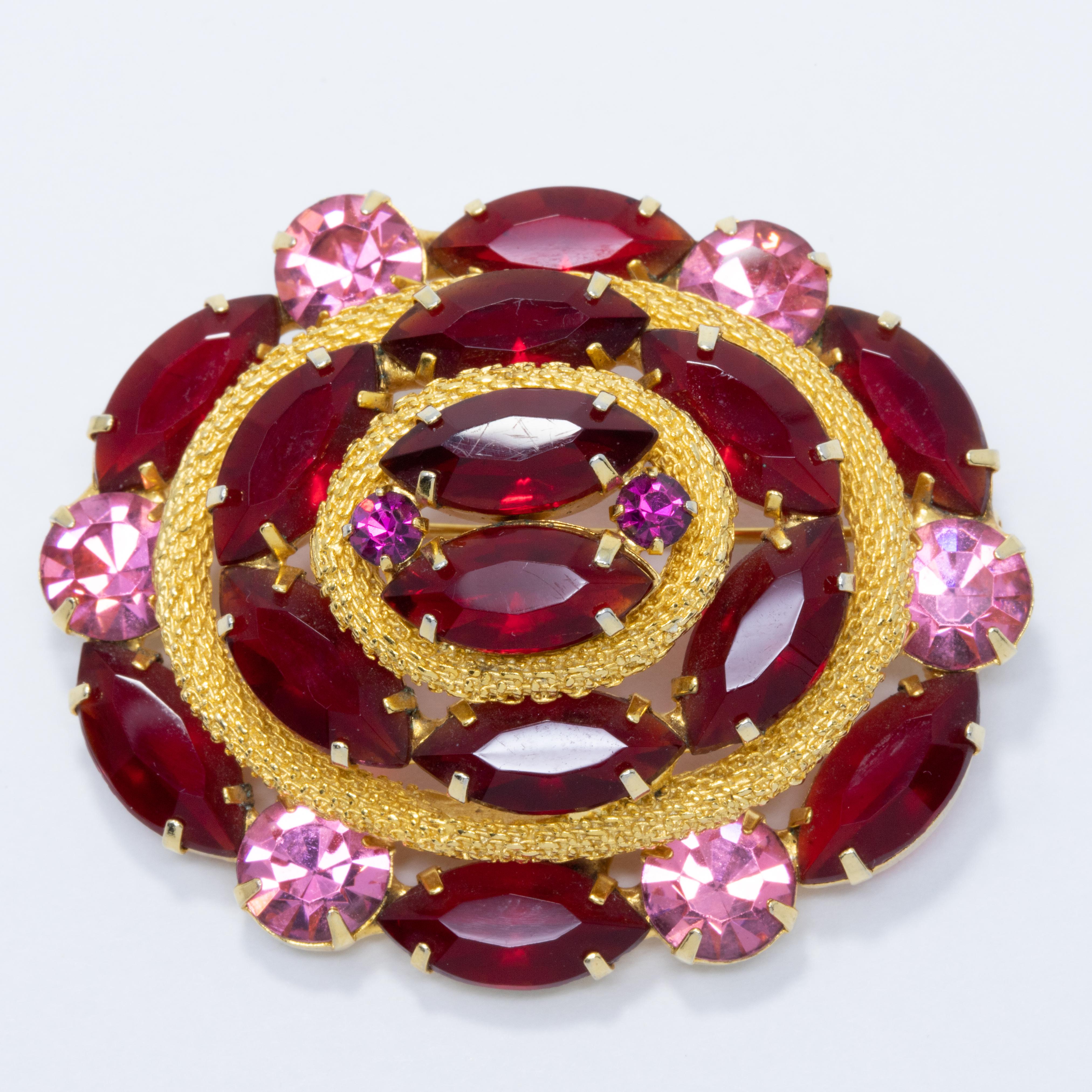 An extravagant set of clip on earrings and a brooch, decorated with open-back ruby and amethyst crystals and set in a gold-plated setting. Reminiscent of lavish Victorian styles, this set is sure to impress!

From vintage stock that has never been