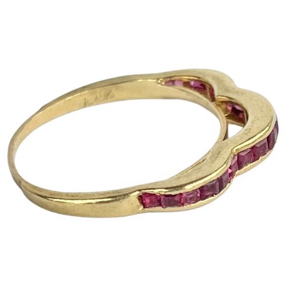 The rubies set within this 18ct gold band are square cut and total approx 70pts. They have a great shine to them and are beautifully bright stones. 

Ring Size: L 1/2 or 6 
Band Width: 2mm 

Weight: 2.2g