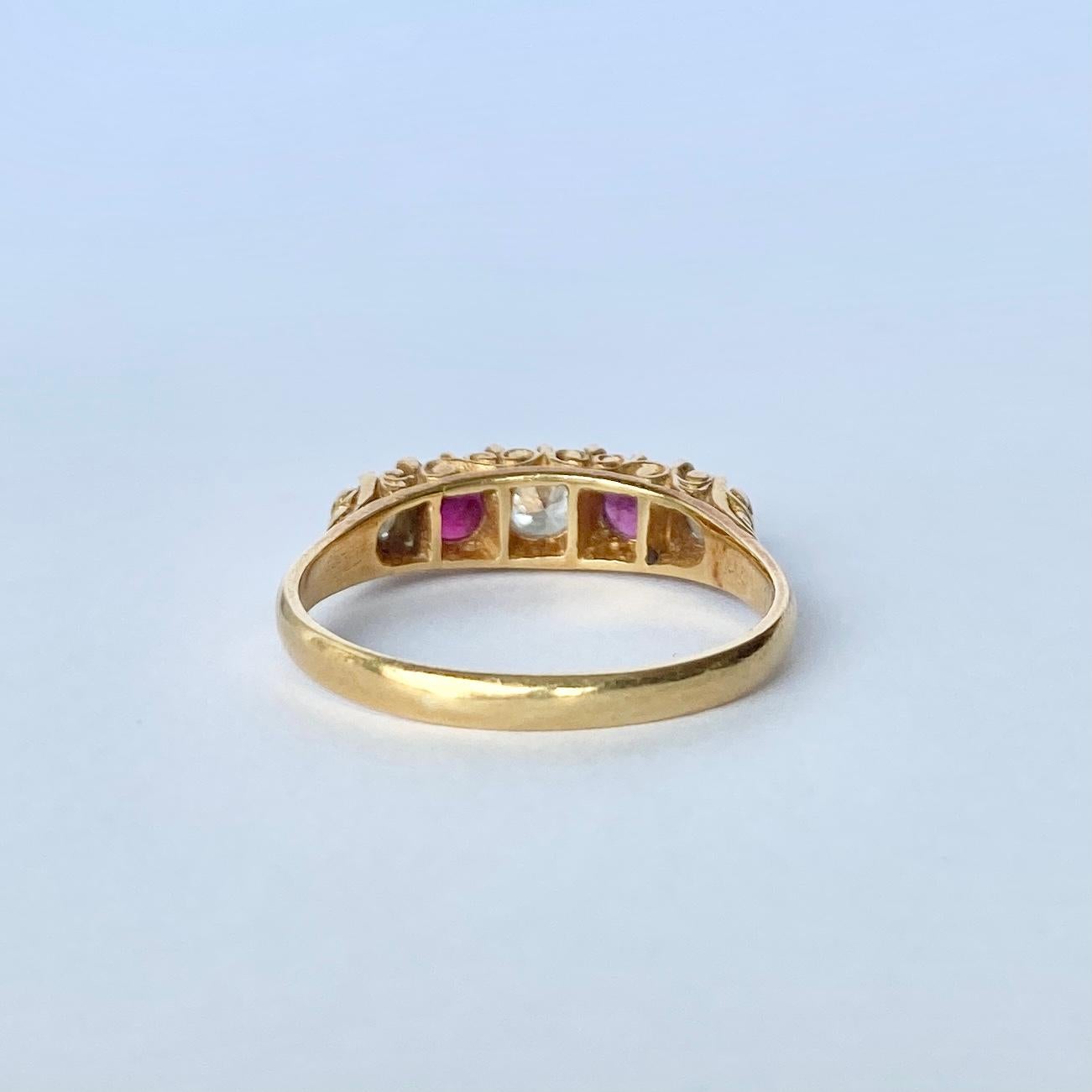 Set in this glossy 18ct gold ring are three Diamonds and two Rubies. The three diamonds total 45pts and the rubies total 30pts. The stones are set in simple claw settings and sit quite flush within the ornate band. Hallmarked London 1976.

Ring