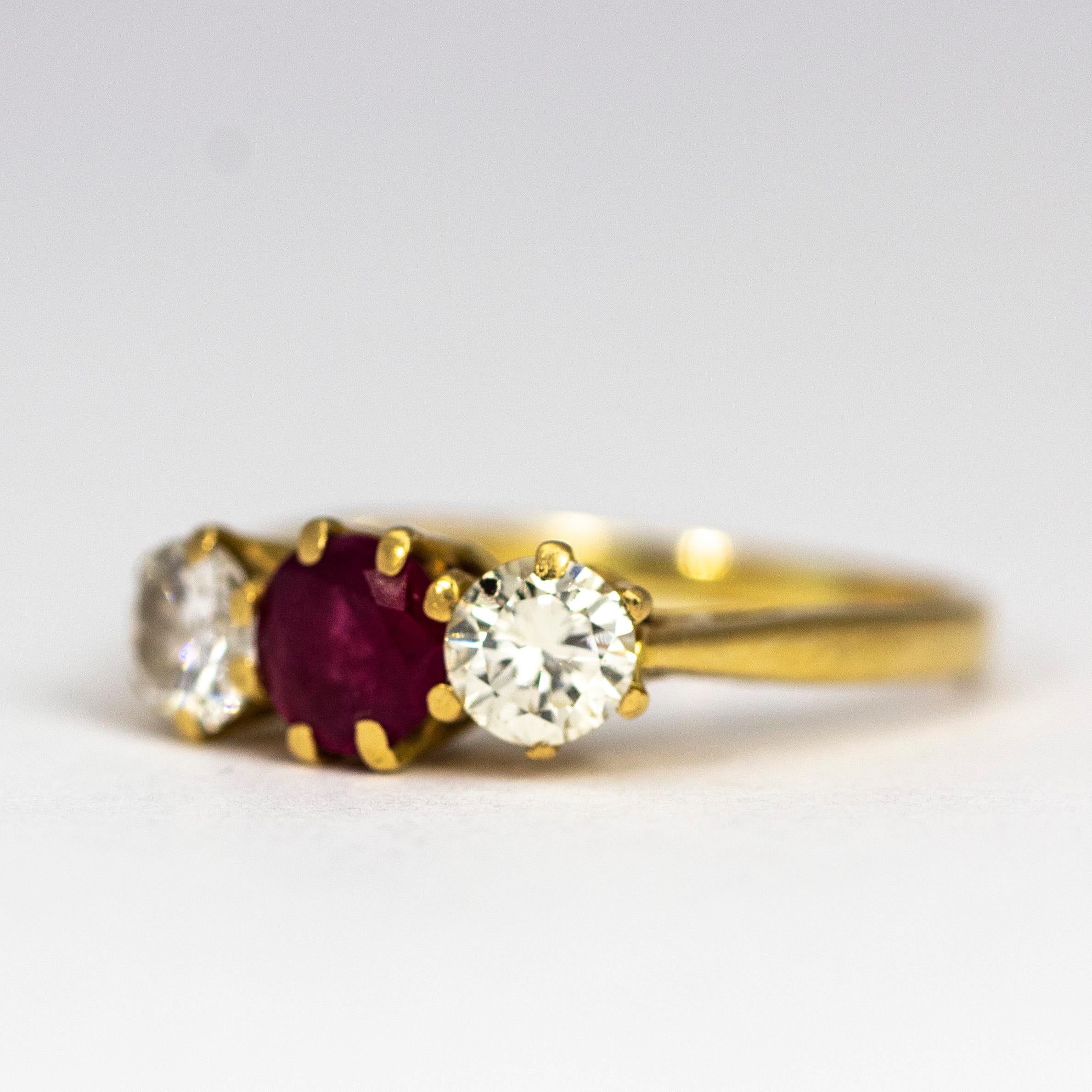 The stunning ruby at the centre of this three stone ring measures 50pts and either side of it sits a diamond measuring 35pts each. The diamonds are old European cut and the ruby has a wonderful deep pink colour. 

Ring Size: K or 5 1/4

Weight: