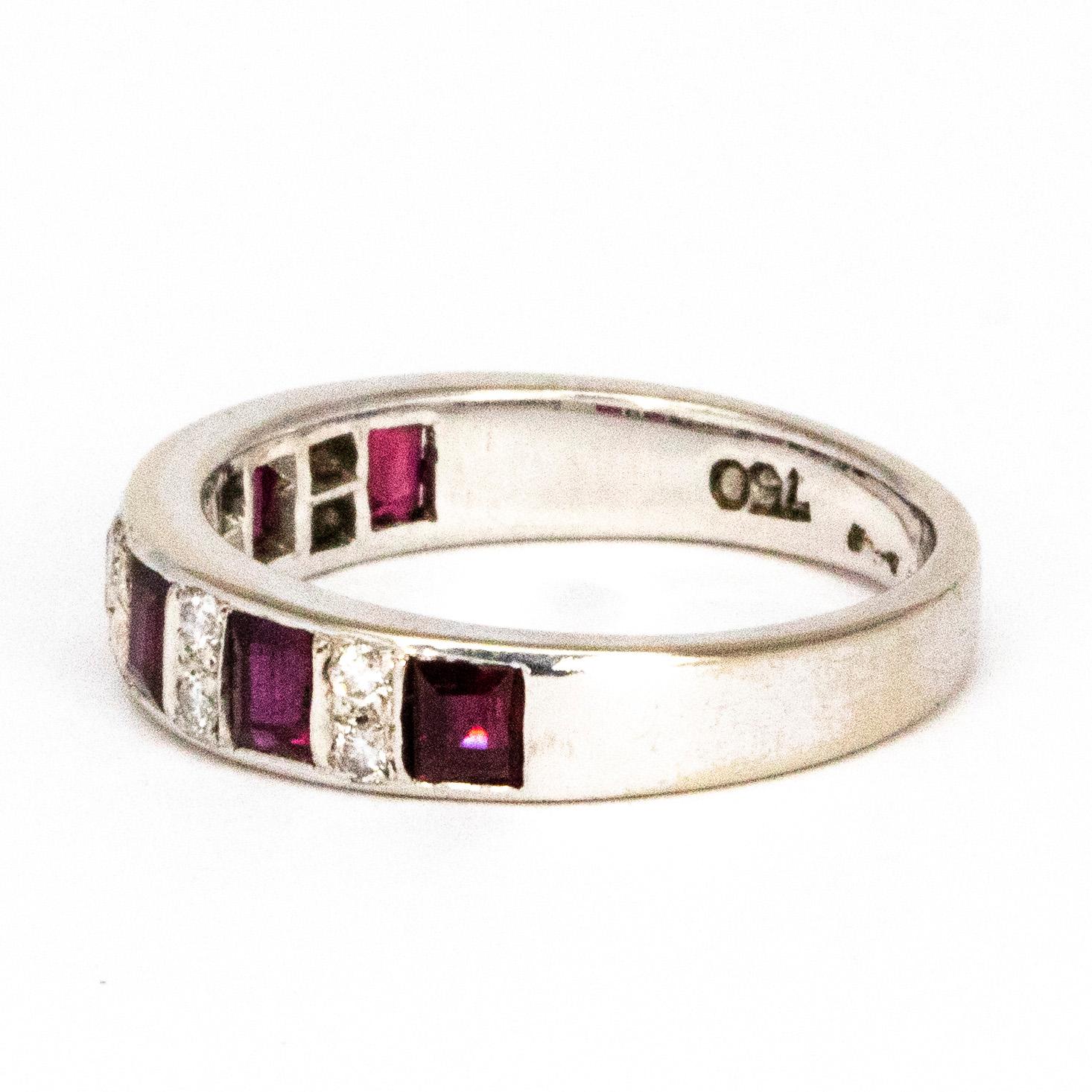 This gorgeous eternity band holds a 25 pt square cut ruby in-between every pair of vertical 3pt diamonds. The rubies ave a gorgeous rich red colour ad the diamonds are bright and sparkling. 

Ring Size: M 6 1/4
Band Width: 4.5mm 