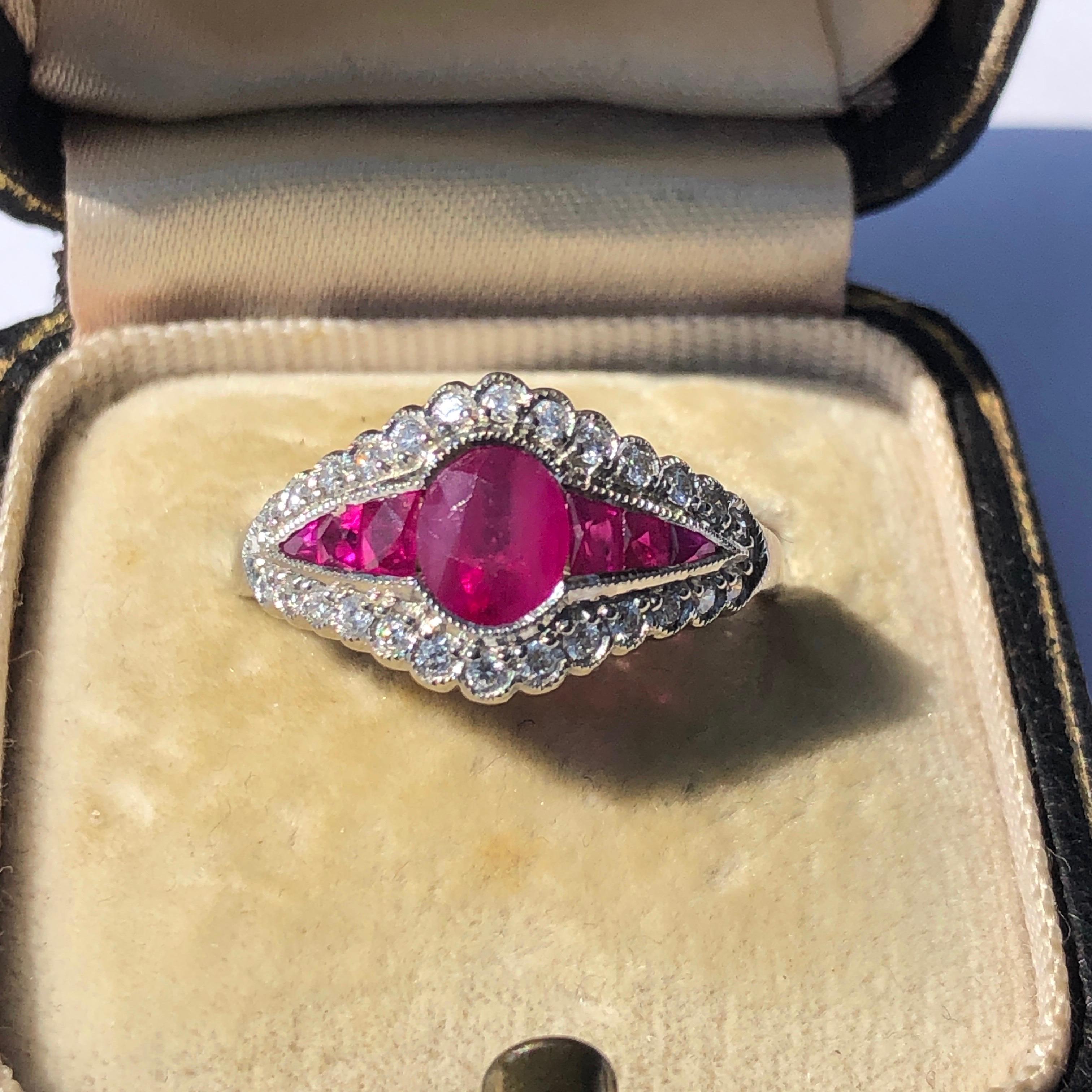 The design of this ring is absolutely show stopping! The rubies total 1.30ct and the diamonds .26ct G/H colour VS S1. The rubies are a gorgeous bright pink colour. The central ruby is an oval shape and the stones either side are tapered down to a
