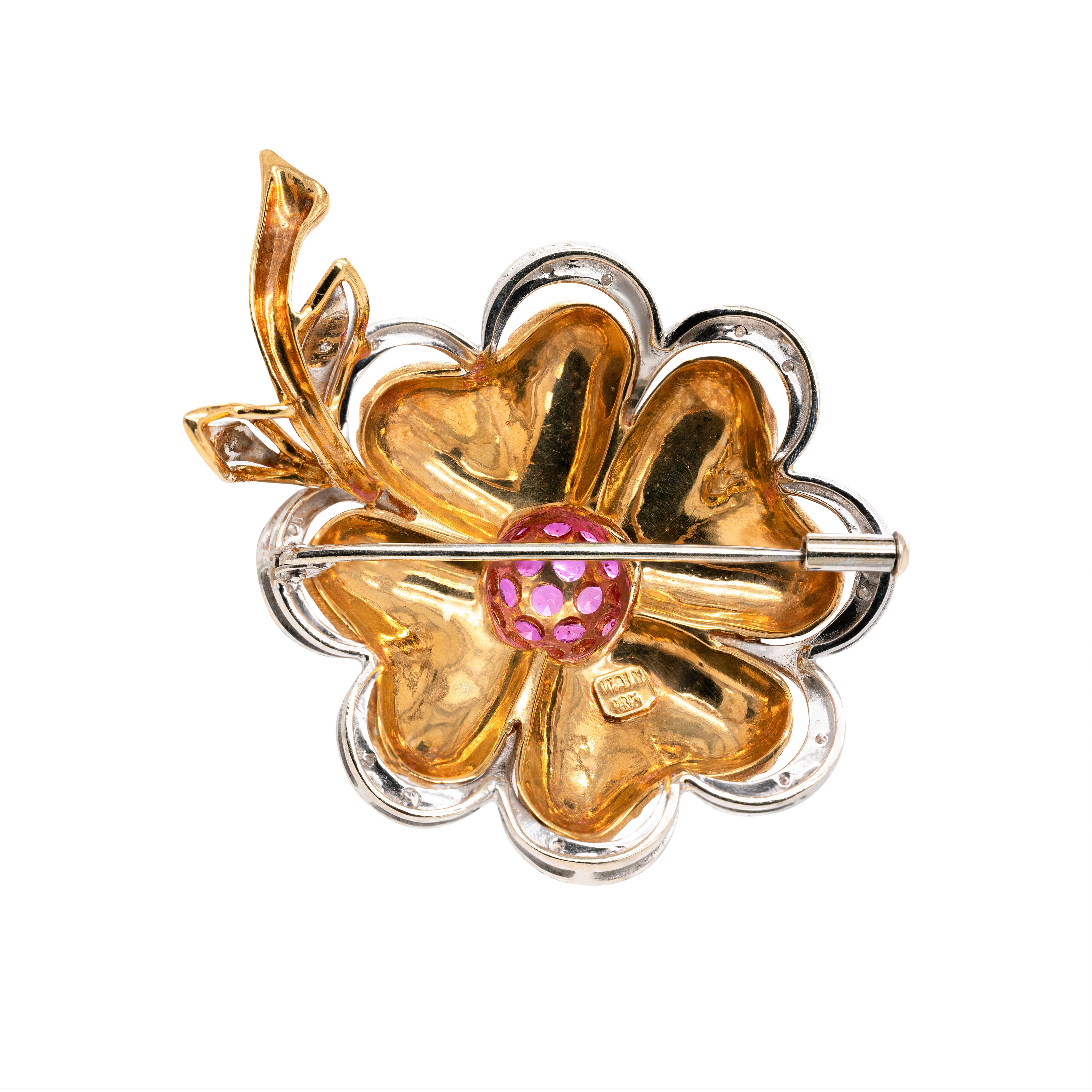 This charming brooch is beautifully designed with 19 round shaped vibrant rubies in the domed centre, weighing approximately 2.00ct combined. The flower's petals are crafted from scaled textured 18 carat yellow gold and highlighted by 18 carat white
