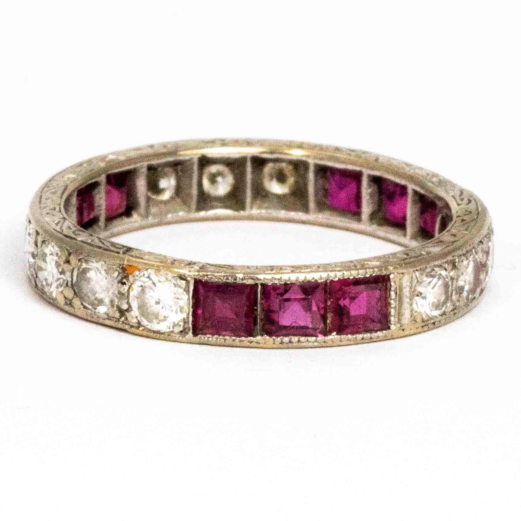 This full eternity ring is absolutely stunning! The ring boasts a total of 1.10ct of round cut diamonds and also hold square cut rubies. The stones are in collections of three or four and are all set in square settings. The band itself is engraved