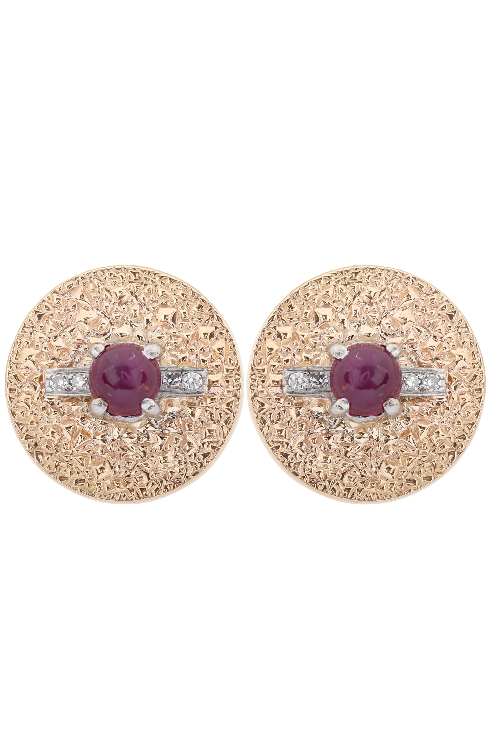 Vintage circle disc earrings with cabochon ruby at center and small diamond accents. The ruby measures 5.8 x 5.8 mm and weighs approximately 1.25 carat each. Beautiful textured surface adds dimension to the piece. The earrings were crafted with 14k