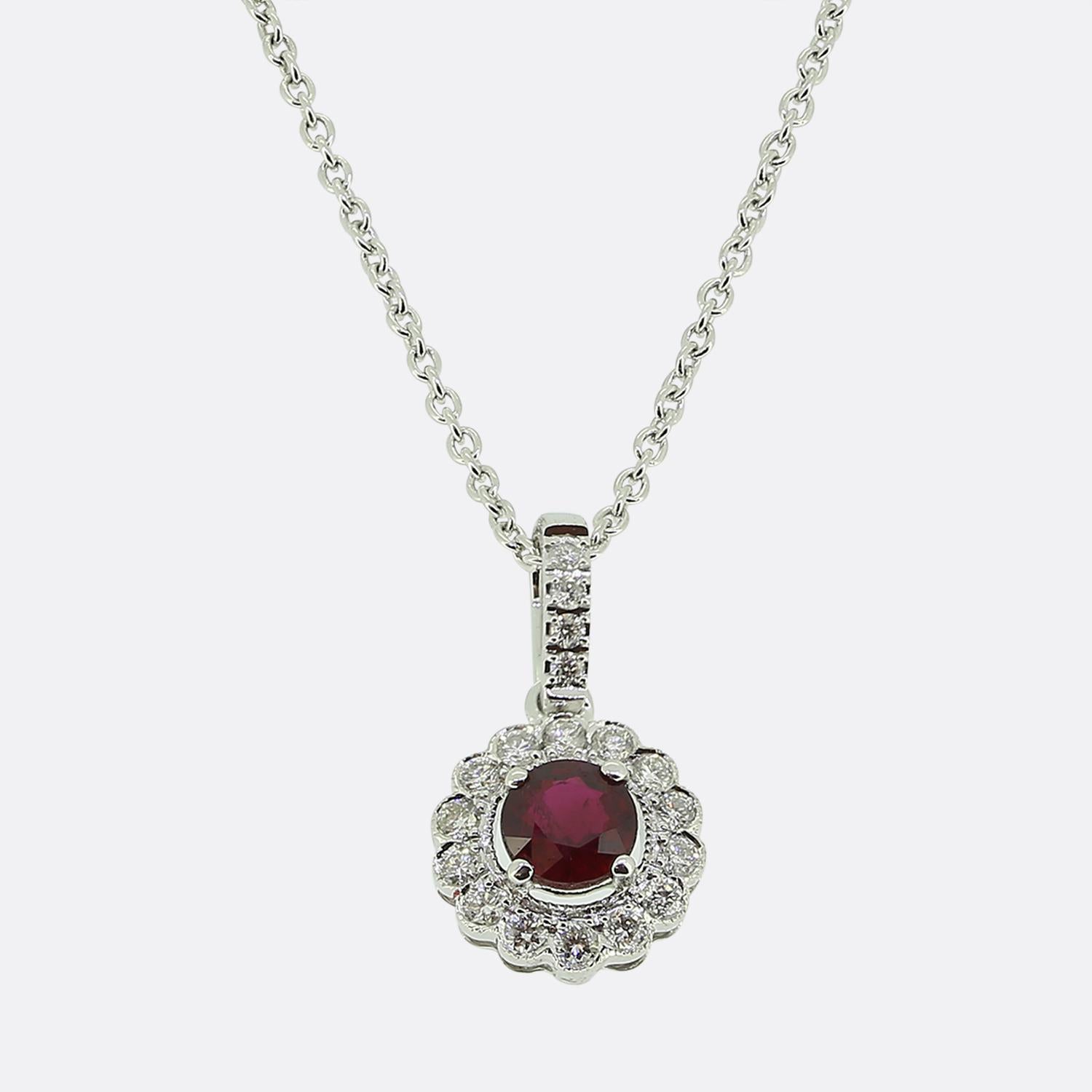 Nous avons ici un collier à pendentifs en rubis et diamants de style classique. Cette pièce vintage a été réalisée en or blanc 18 carats et présente au centre un rubis rouge riche et rond à facettes. Cette pierre principale est légèrement surélevée