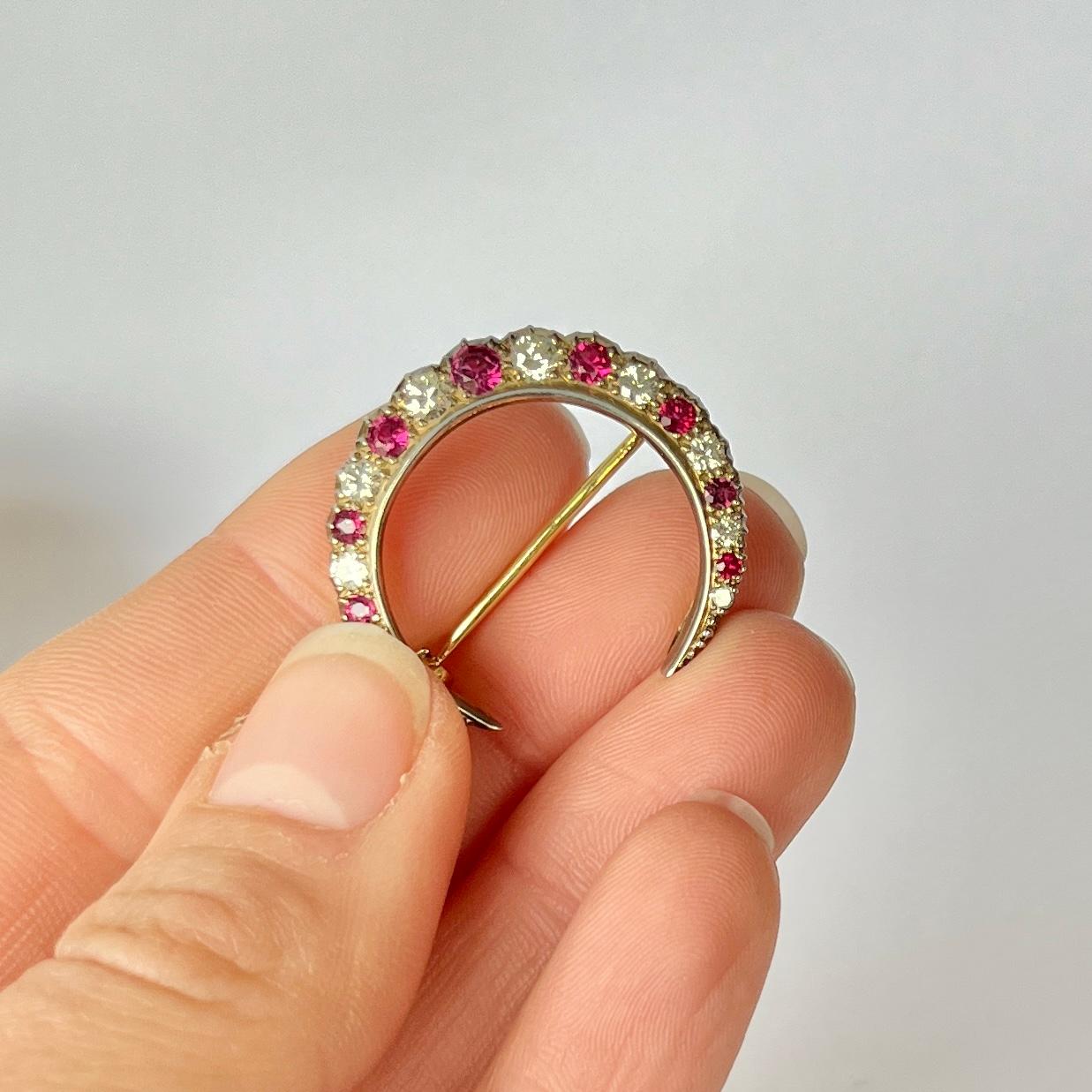 This stylish crescent brooch holds a total of 9 rubies and 10 diamonds. The rubies total approximately 65pts and the diamonds total aproximately 80pts. The brooch is modelled out of 18carat gold.

Brooch Dimensions: 26x25mm

Weight: 4.3g