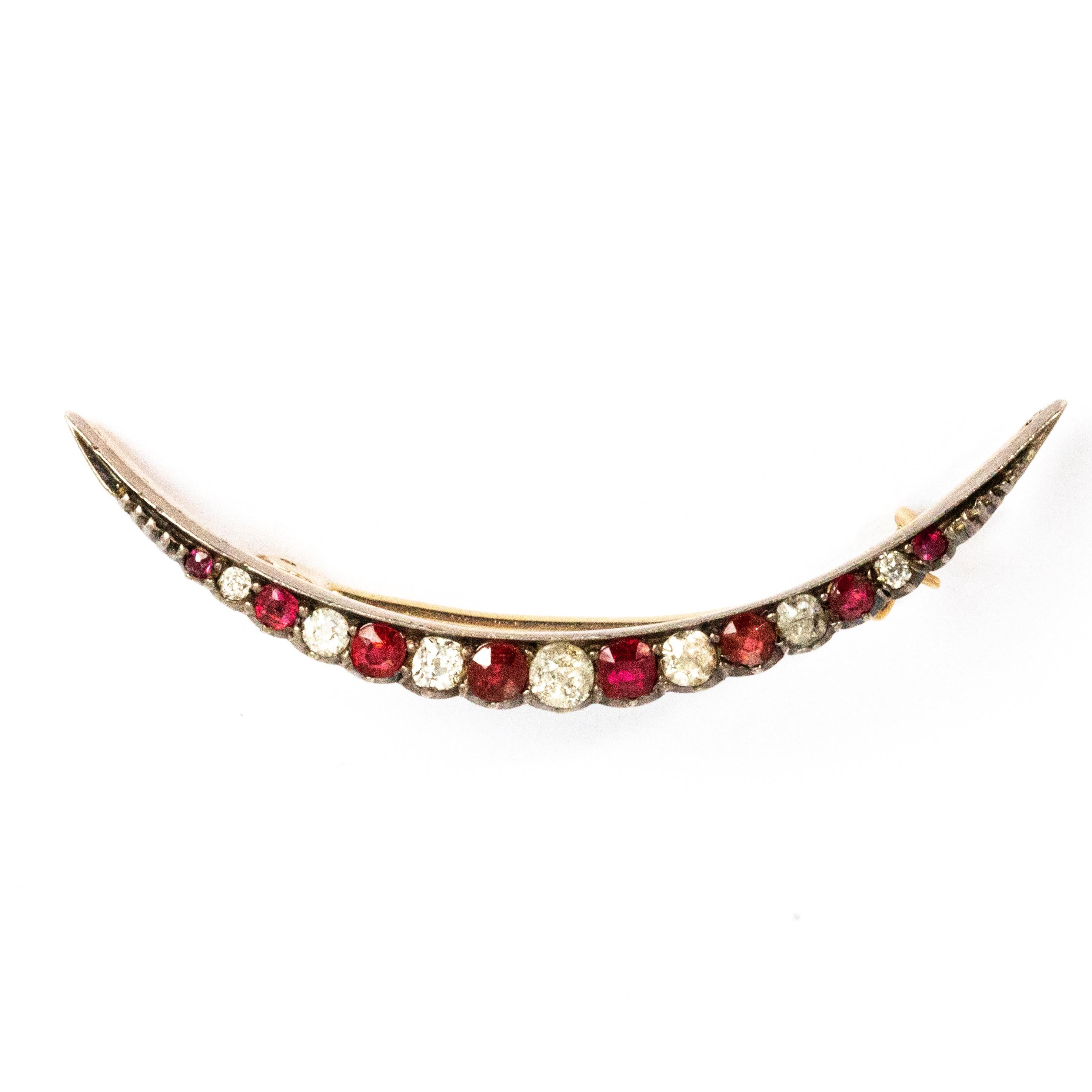 This stylish crescent brooch holds a total of 8 rubies and 7 diamonds. The rubies total approximately 68pts and the diamonds total aproximately 44pts. The brooch is modelled out of silver.

Brooch length: 2inches