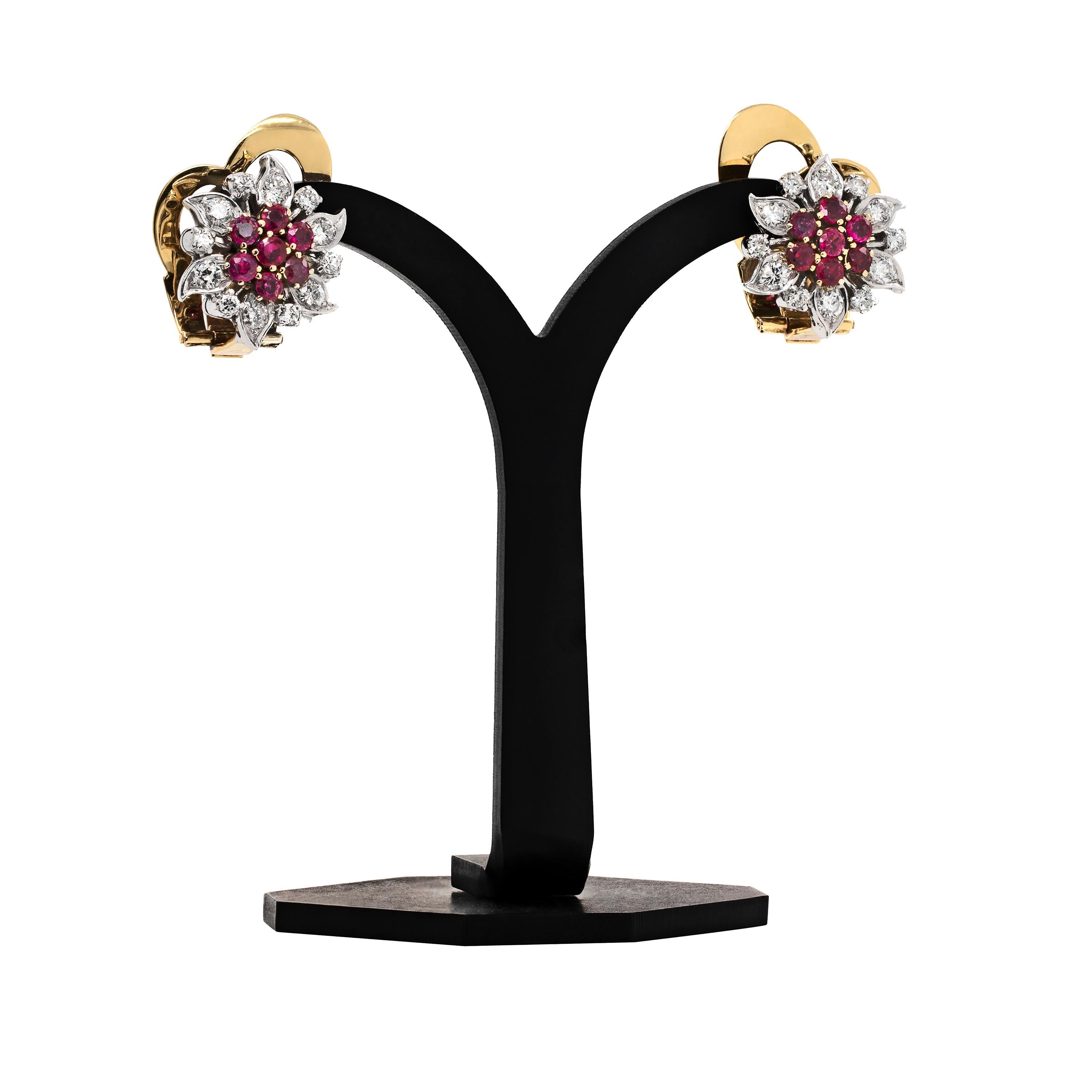 These beautiful vintage earrings feature seven round shaped vibrant rubies in the centre, weighing a total approximate weight of 1.20ct, all mounted in open back, 18 carat yellow gold four claw settings. To complete the floral design of these