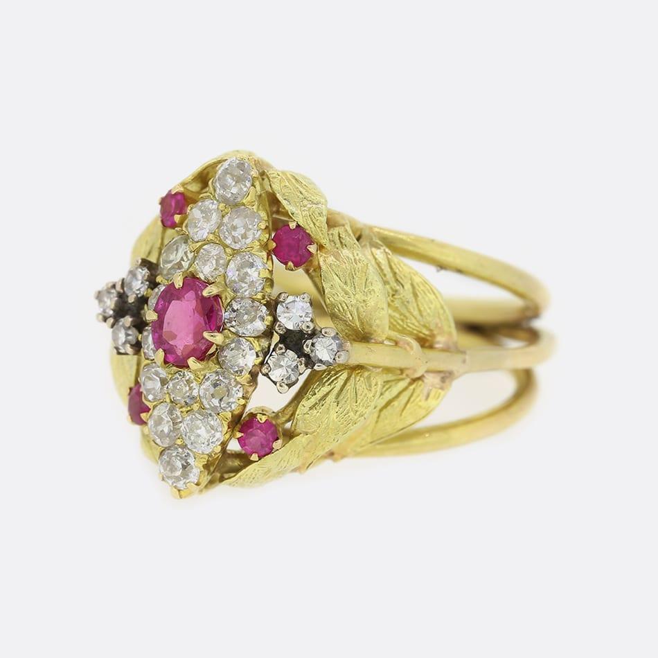 This is a vintage 18ct yellow gold ruby and diamond navette ring. The centre of the ring is composed of 22 diamonds and 5 beautiful rubies with a pinky red tone. On each shoulder there are 6 leafs that graduate up to the face.

Condition: Used (Very