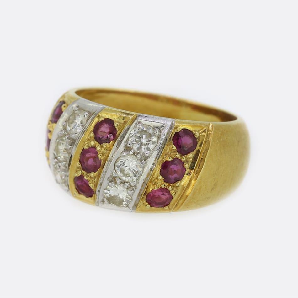 This is an 18ct yellow gold ruby and diamond ring. The ring features a pattern of 3 vertically rubies followed by 3 diamonds. The rubies are perfectly matched and have a lovely deep red hue, which is highly complimented by the white sparkle of the