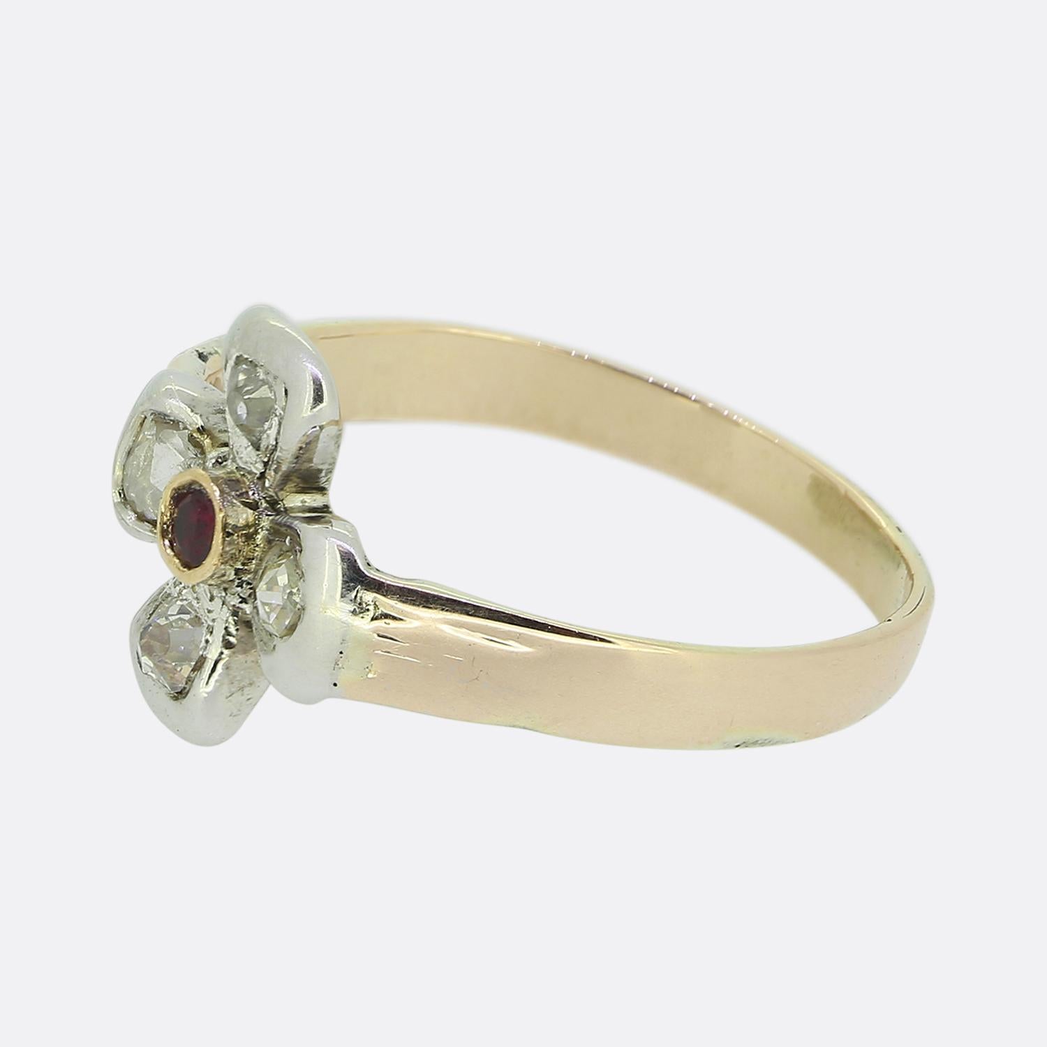 Here we have a lovely ruby and diamond ring. The face of this vintage piece has been crafted from 9ct white gold into the shape of a flower head with each petal-like setting playing host to a single natural diamond; two of which are old cut cuts