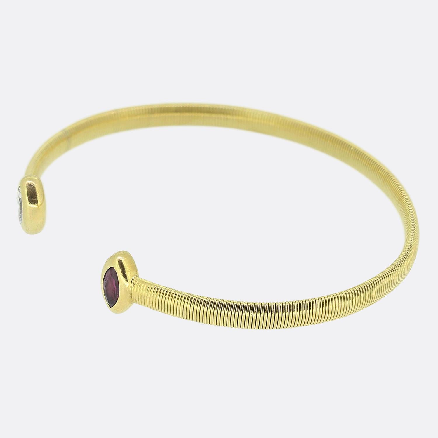 Here we have an chic and stylish torc bangle. This vintage piece has been crafted from a rich 18ct yellow gold and showcases a ribbed bracelet design which plays host to a duo of marquise cut precious gemstones at either ending including a rich
