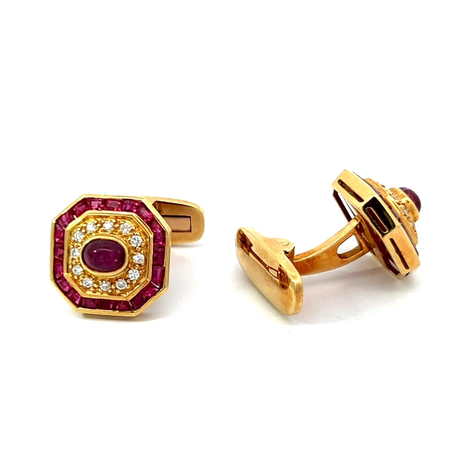 This elegant circa 1970 cufflink and stud set features a striking octagonal design crafted in rich 18k yellow gold. Each piece is adorned with a central cabochon ruby, beautifully framed by a halo of sparkling diamonds and additional calibré-cut