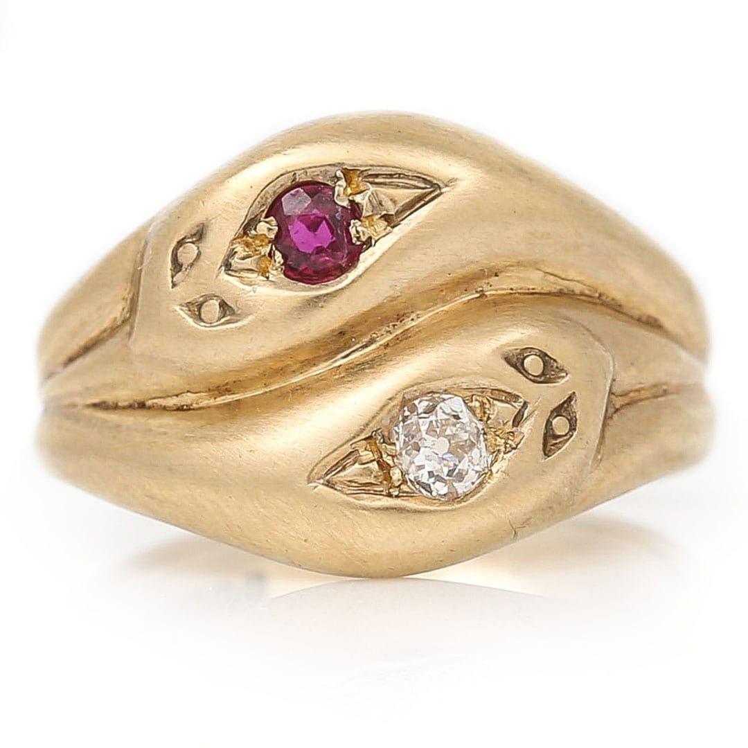 This super vintage 9k yellow brushed gold old cut diamond and ruby ring is beautifully crafted in the style of two snake or serpents heads entwined. The two snakes entwined symbolise two lovers eternal and never ending love for one another. In this