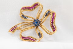 Spilla vintage con rubino e zaffiro incastonati in oro giallo 18 carati