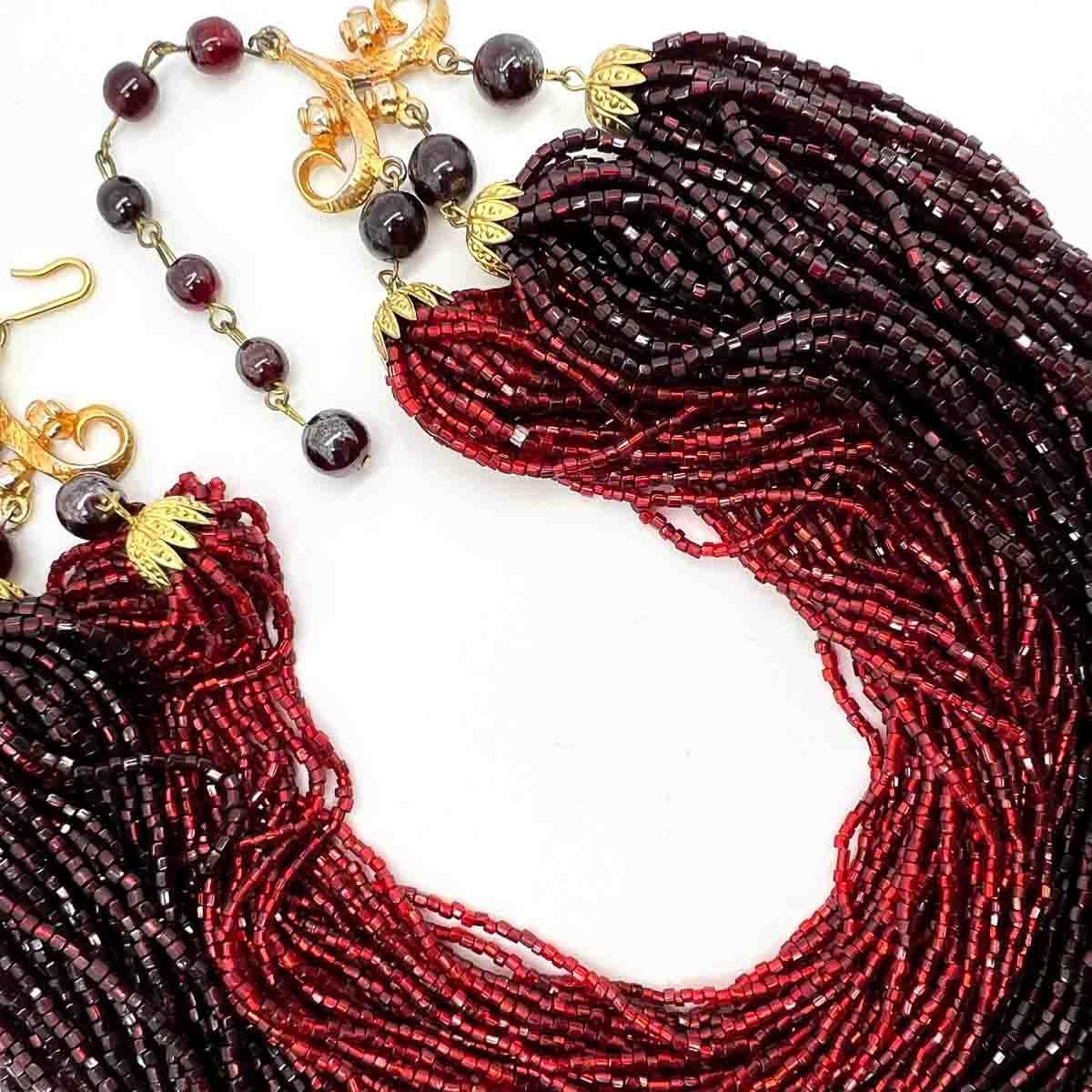 A superb Vintage Ruby Glass Torsade Necklace. The epitome of glam chic, hailing from the 1940s.
An unsigned beauty. A rare treasure. Just because a jewel doesn’t carry a designer name, doesn’t mean it isn't coveted. The unsigned beauties in our