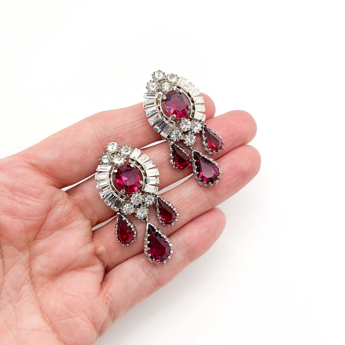 A delightful pair of Vintage Ruby Crystal Droplet Earrings. Most likely by mid century London jeweller, Mitchel Maer however unsigned. Crafted during the 1950s these exquisite earrings featuring superb fancy cut crystals in ruby and white. A