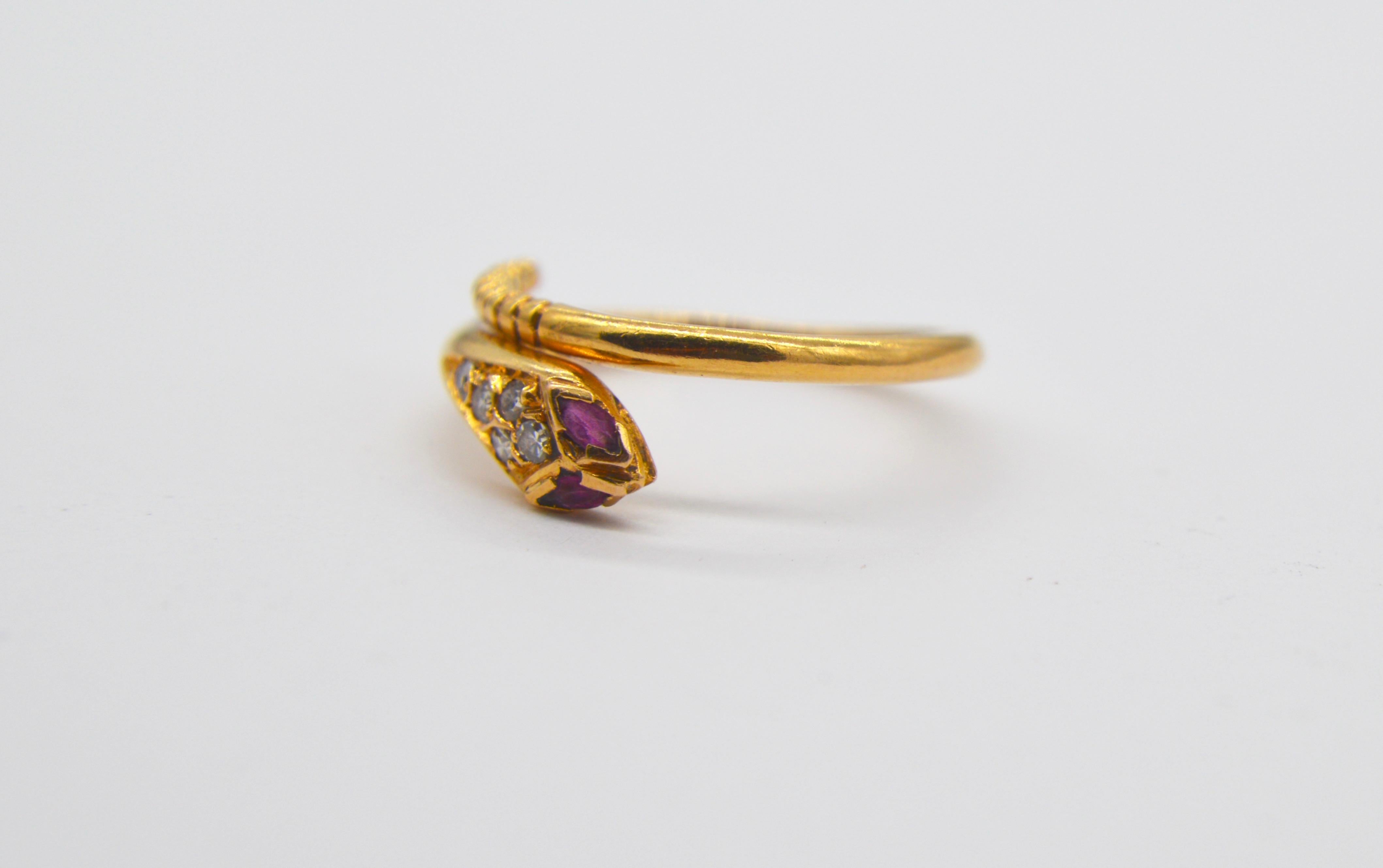 Beautiful vintage midcentury 1960s snake wrap ring in 18K yellow gold with marquis ruby eyes and round cut diamonds. In good condition. Diamonds graded as VS2, measure 1.5mm each in diameter. Natural ruby marquis each measure 2.5mm long. Size can be