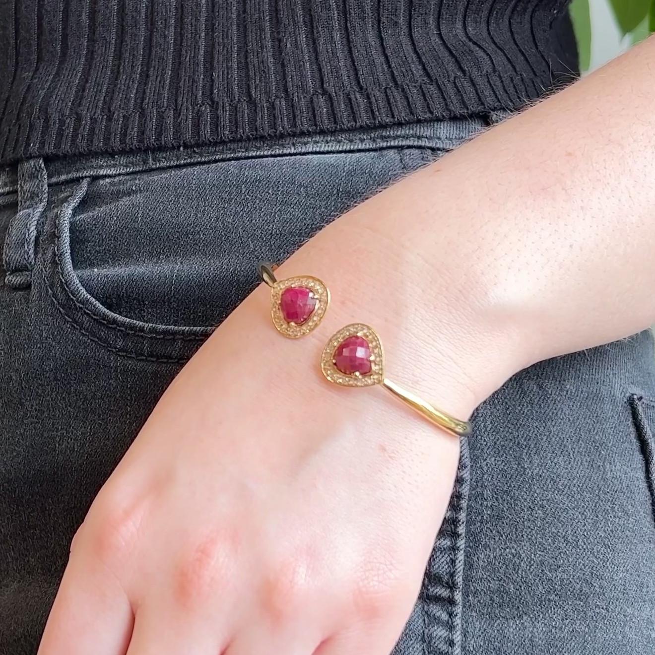 One Vintage Ruby Diamond 18 Karat Yellow Gold Cuff Bracelet. Featuring two pear shaped checkerboard cabochon cut rubies with a total weight of approximately 8.00 carats. Accented by 44 round brilliant cut diamonds with a total weight of