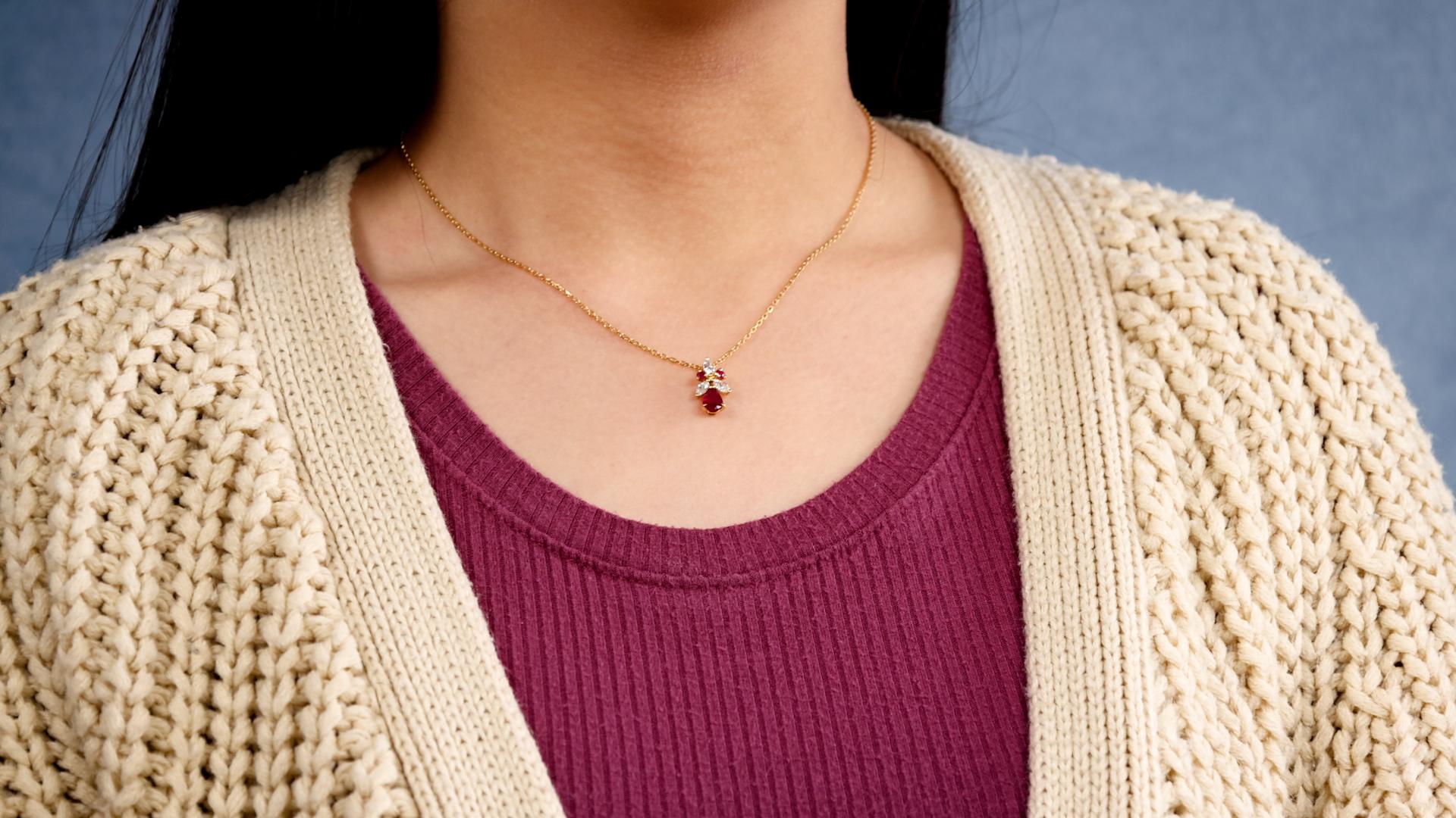 One Vintage Ruby Diamond 18k Yellow Gold Pendant Necklace. Featuring one pear mixed cut ruby weighing approximately 0.60 carat. Accented by three marquise cut diamonds with a total weight of approximately 0.25 carat, graded I-J color, VS clarity and