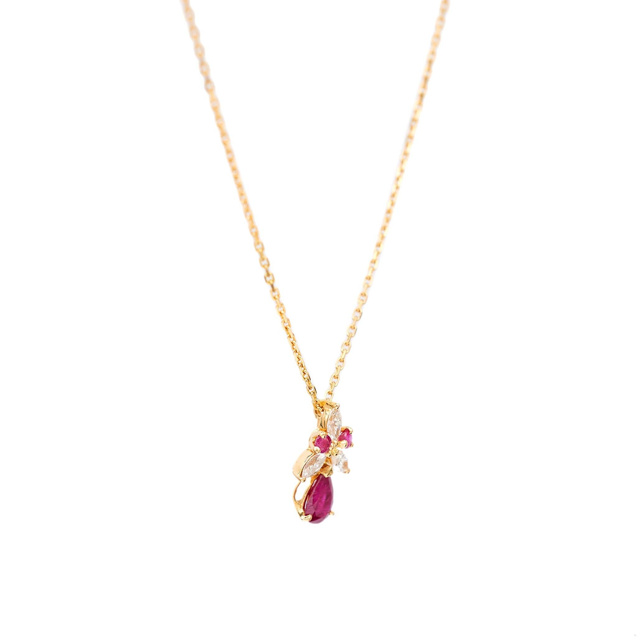 One Vintage Ruby Diamond 18k Yellow Gold Pendant Necklace. Featuring one pear mixed cut ruby weighing approximately 0.60 carat. Accented by three marquise cut diamonds with a total weight of approximately 0.25 carat, graded I-J color, VS clarity and