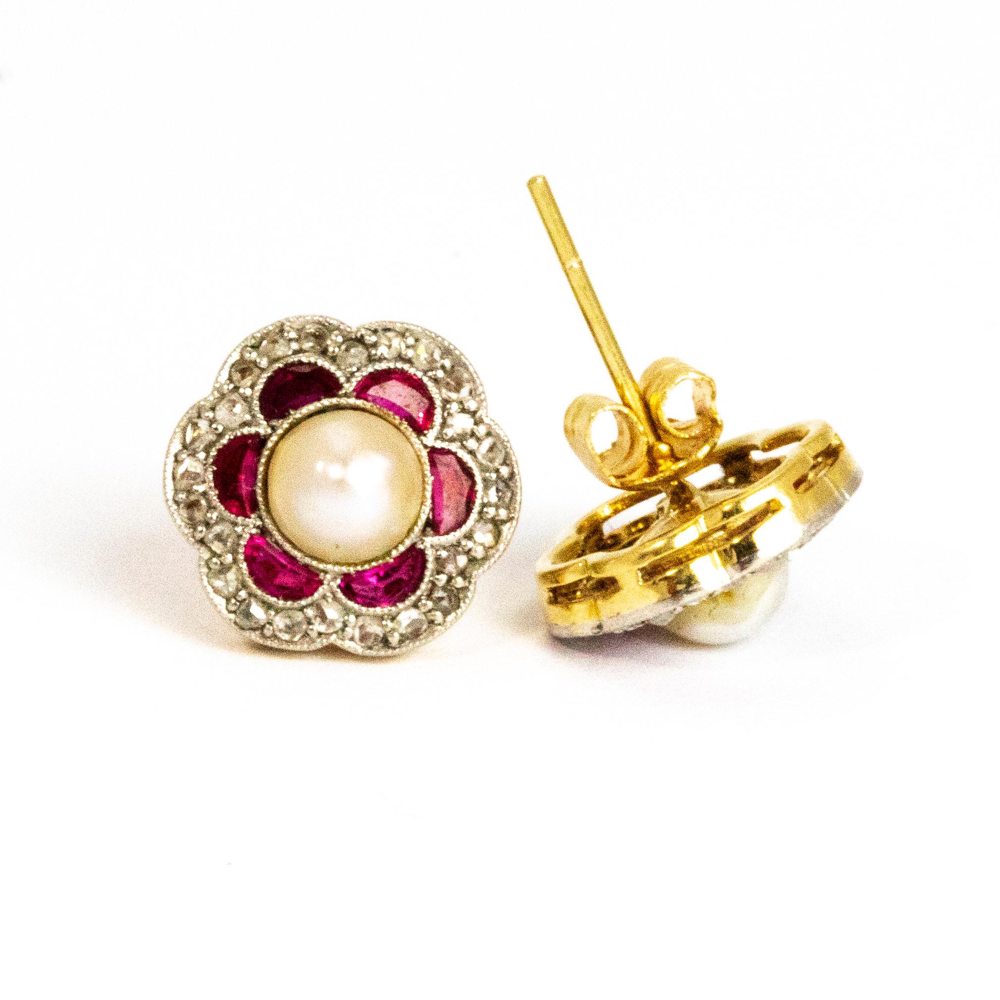 This pair of Vintage cluster earrings are classically stunning. They hold a lovely size pearl at the centre of the cluster which is surrounded by crescent Rubies. The outer edge of the earrings hosts an outline of tiny diamonds that give a charming