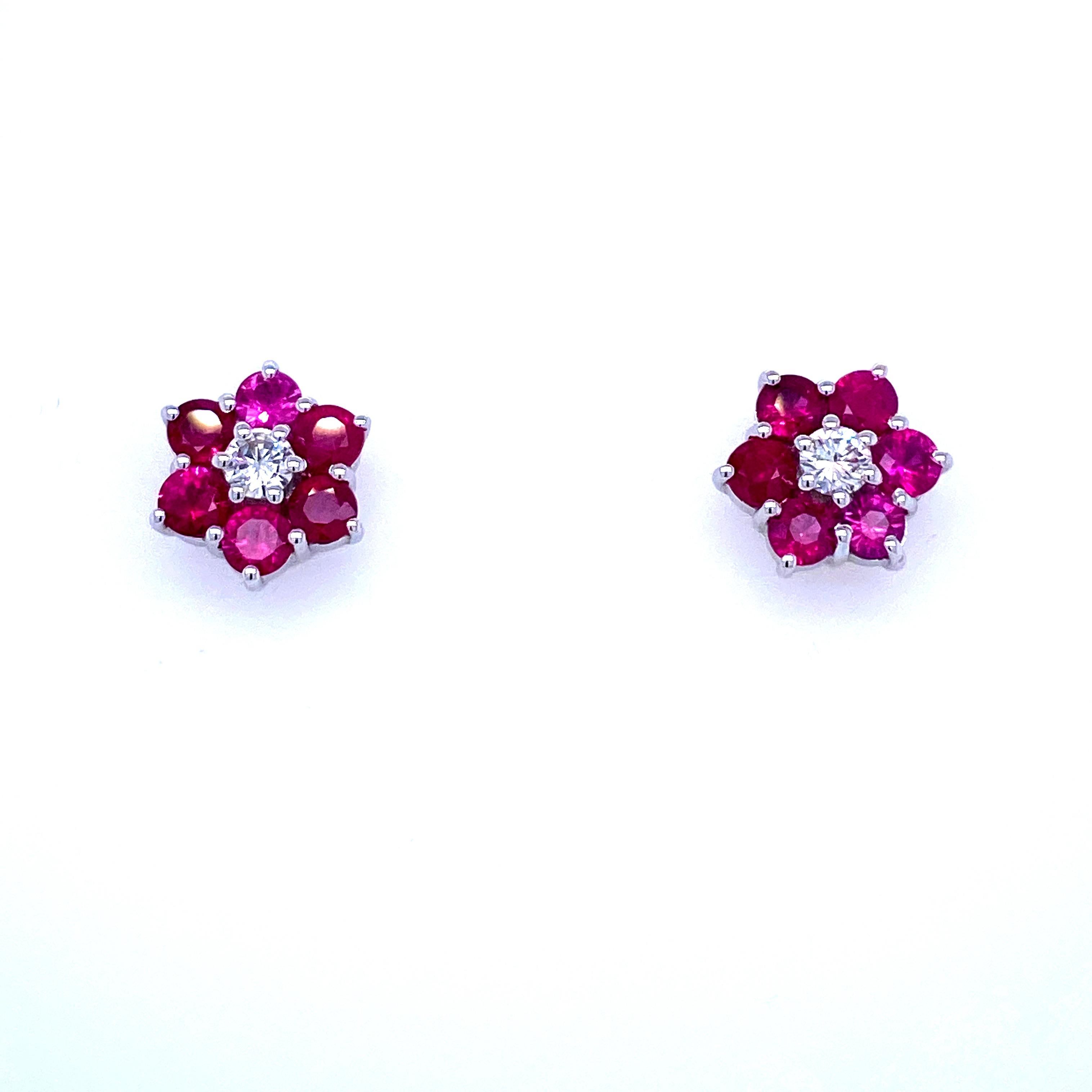 Pretty pair of vintage diamond cluster earrings set in solid 18k Gold. They are set with Natural Ruby and with two large Round Brilliant cut Diamonds in the center graded color G clarity Vvs2. 
Origin Italy 1980

CONDITION: Pre-owned - Excellent