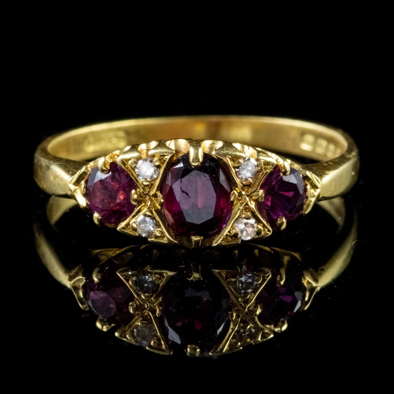 This stunning Vintage Gypsy ring has been modelled in 18ct Yellow Gold and set with a trilogy of deep red Rubies, with the central Ruby weighing 0.30ct and the Rubies either side weighing 0.20ct each. Nestled between the Rubies sit four sparkling