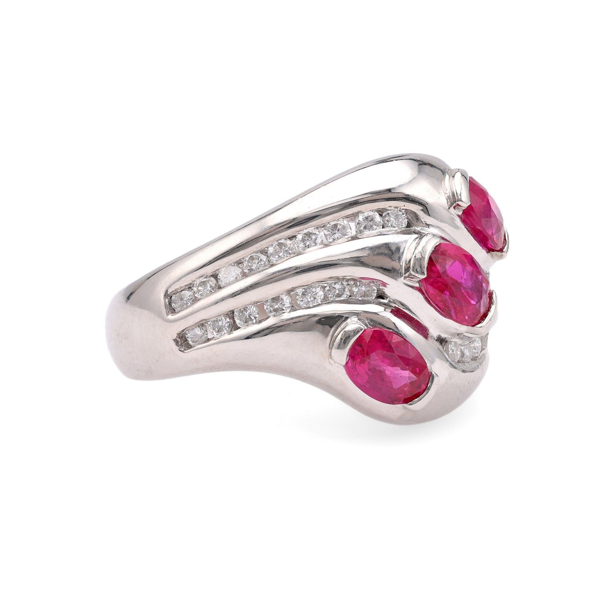 One Vintage Ruby Diamond Platinum Ring. Featuring three oval cut rubies with a total weight of 1.19 carats. Accented by 32 round brilliant cut diamonds with a total weight of 0.38 carat, graded G-H color, VS clarity. Crafted in platinum with purity