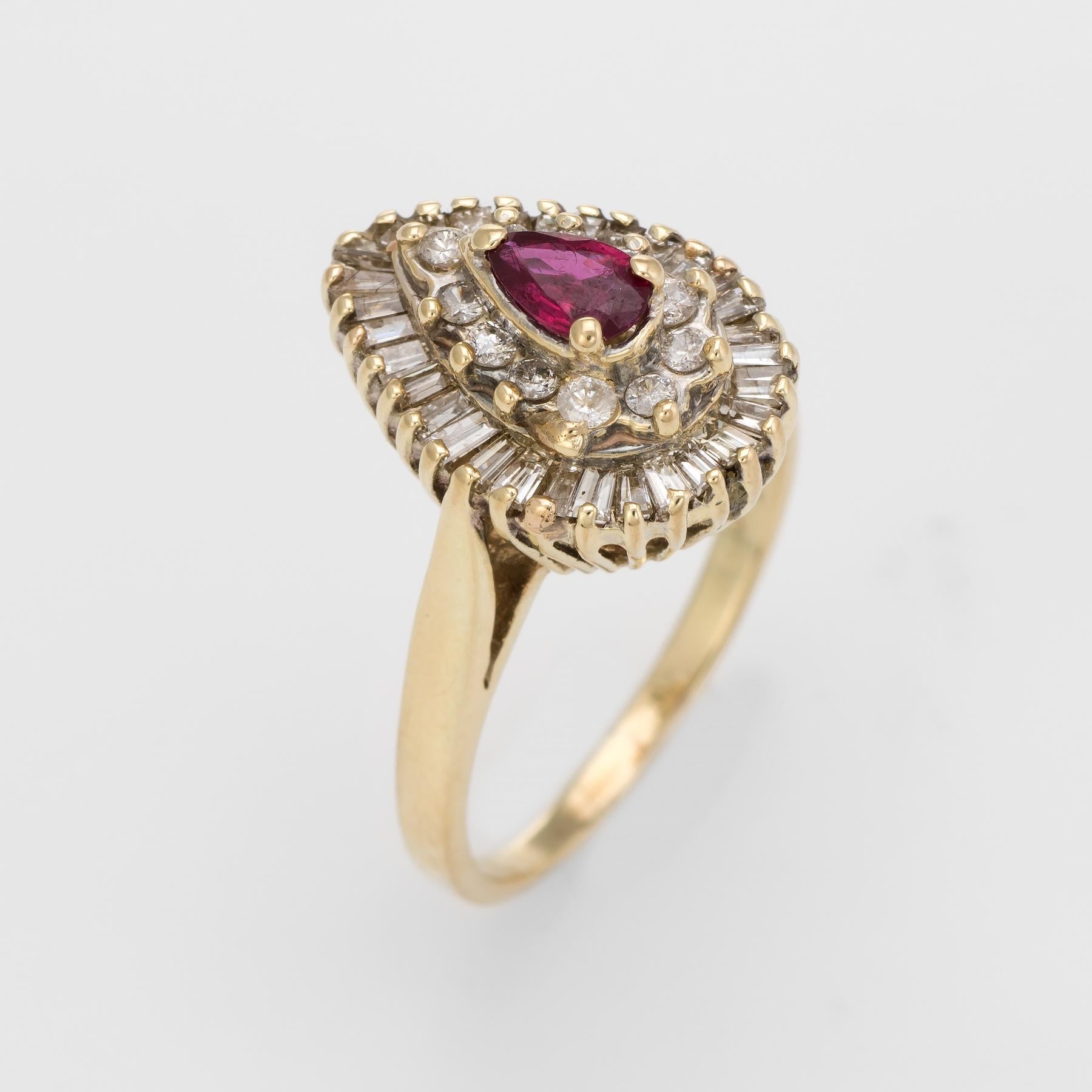 Nicely detailed vintage cluster cocktail ring set with a ruby & diamonds, crafted in 14 karat yellow gold. 

Faceted pear cut ruby measures 5.5mm x 3.5mm (estimated at 0.30 carats), accented with 11 estimated 0.01 carat round brilliant cut diamonds