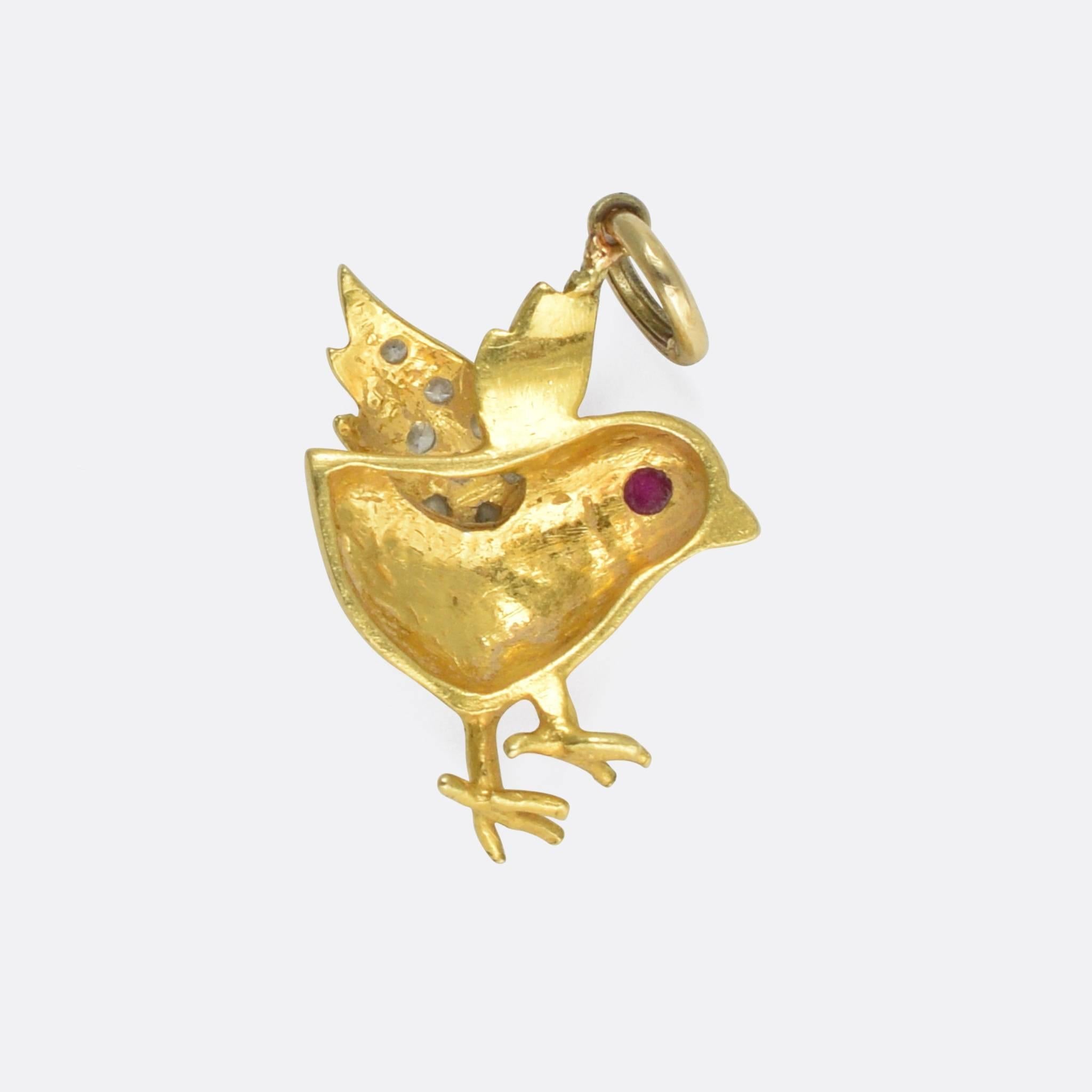 A sweet vintage pendant modelled as a stylized spring chicken. It's set with brilliant cut diamonds and a ruby eye, modelled in two-tone 18 karat gold. Such a cute piece, the perfect addition to your charm collection, or for wear as a single