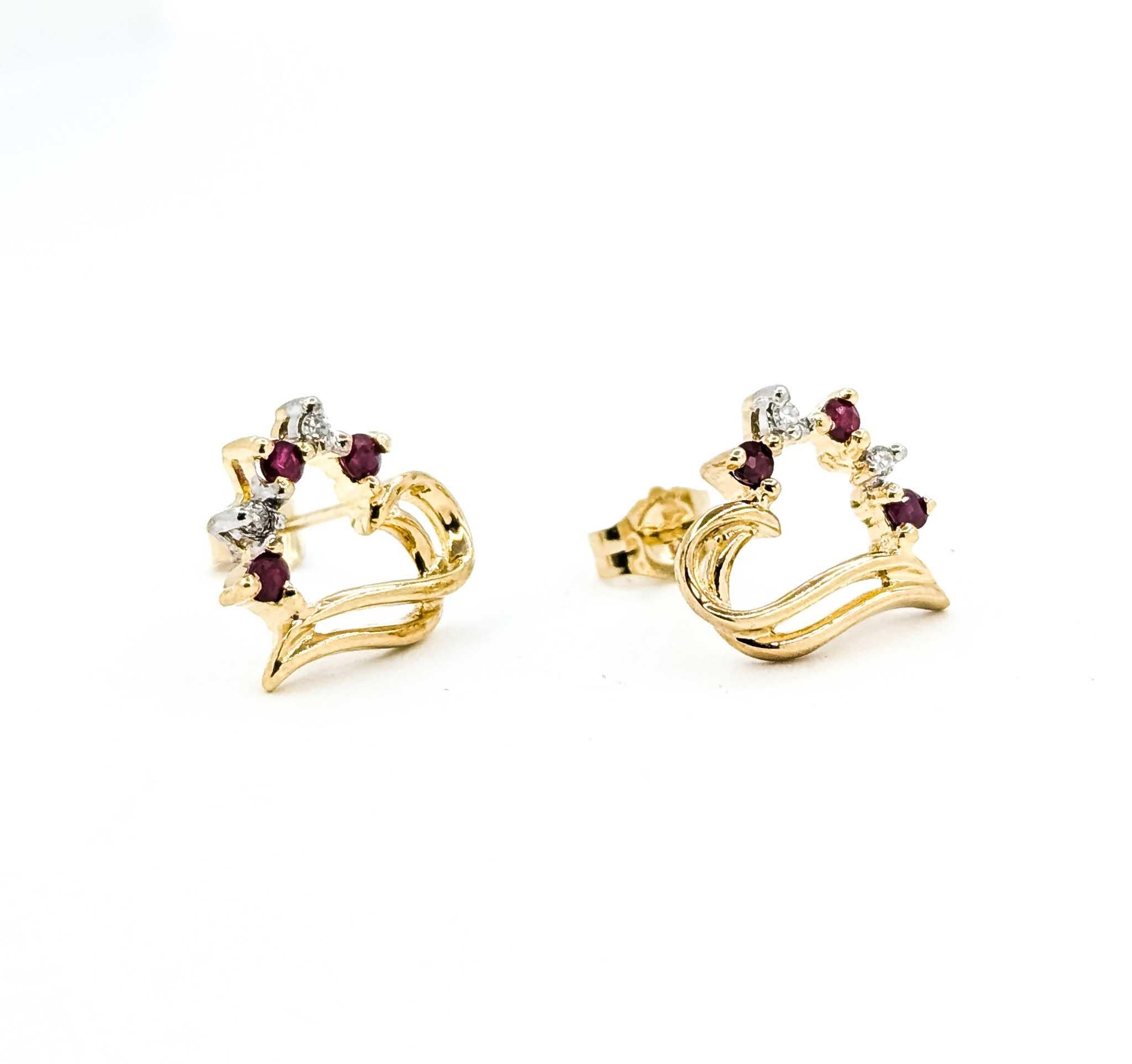 These earrings are crafted in 10k yellow gold and feature ruby, with a vintage heart design. A true example of the Vintage era. The round diamonds total 0.02ctw, near colorless with I clarity. These earrings are accented by round diamonds.

The