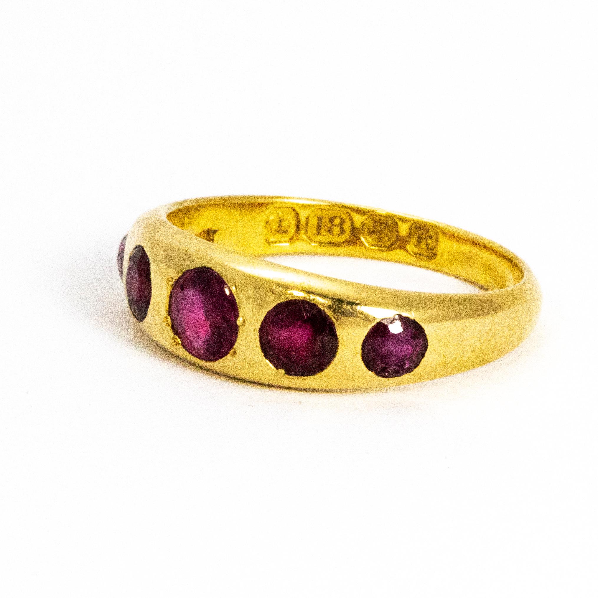 Five graduated sparkling rubies are held in this chunky 18ct gold band. The beautiful rubies are set flush in the band so the ring is very stream lined and smooth. Made in London, England.

Ring Size: K 1/2 or 5 1/2
Band Width: 4mm