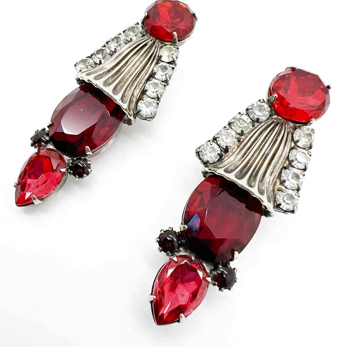 Divine Vintage Ruby Glass Earrings. A clever and elaborate design incorporates large ruby glass stones amongst stylised metal motifs. Attention to detail makes these a truly wearable work of art. A stunning find that will never fail to captivate.
An