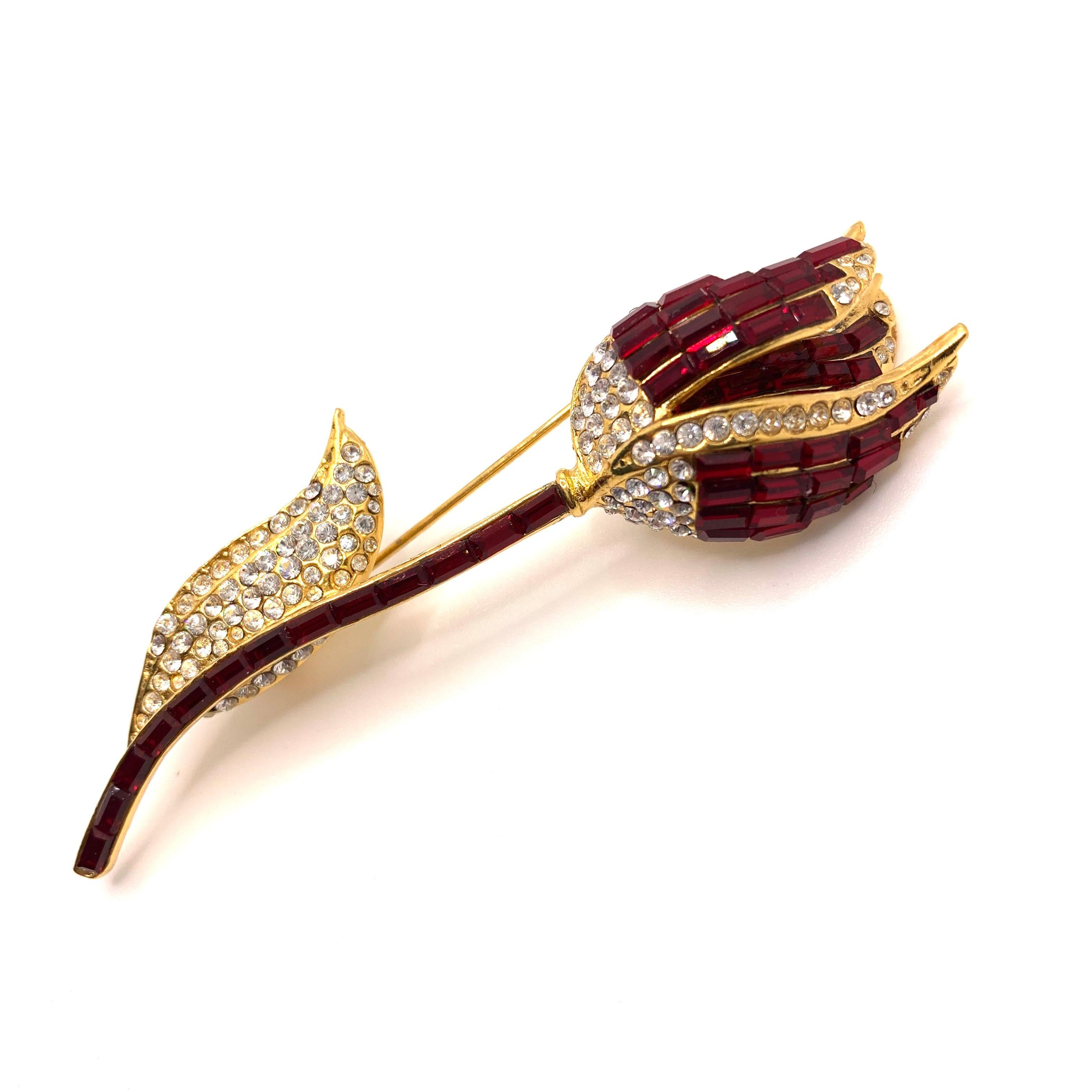 Classic Elegant Vintage Swarovski Ruby Red Tulip Brooch

This vintage brooch features over 180 pieces of red ruby and white Swarovski crystals in yellow gold tone. Made in the USA by New York designer brand Jarin.  3-1/4