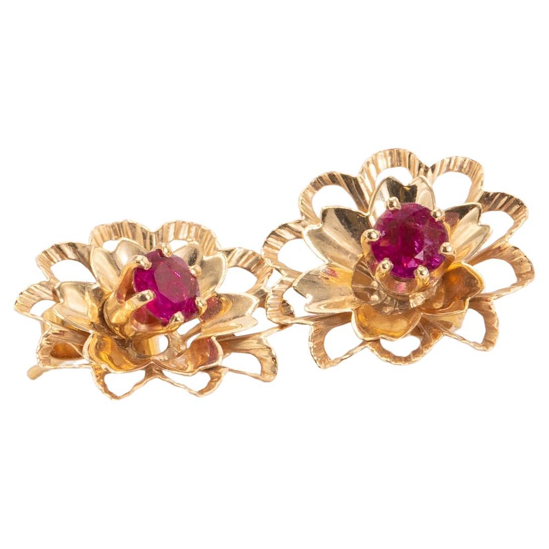 Vintage Ruby Studs with Floral Earring Jackets in 14K Yellow Gold

These exquisite vintage studs from the 1960s are crafted in 14K yellow gold and feature a removable pair of earring jackets, allowing several options for wear:

The 6-prong studs
