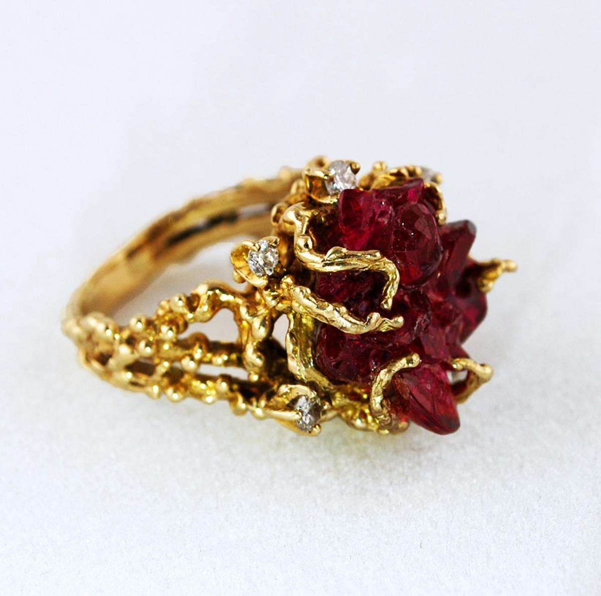 One of the kind bright raw ruby-type chatham crystal in 14K gold castings and diamonds.

The center crystal is approximately 0.6
