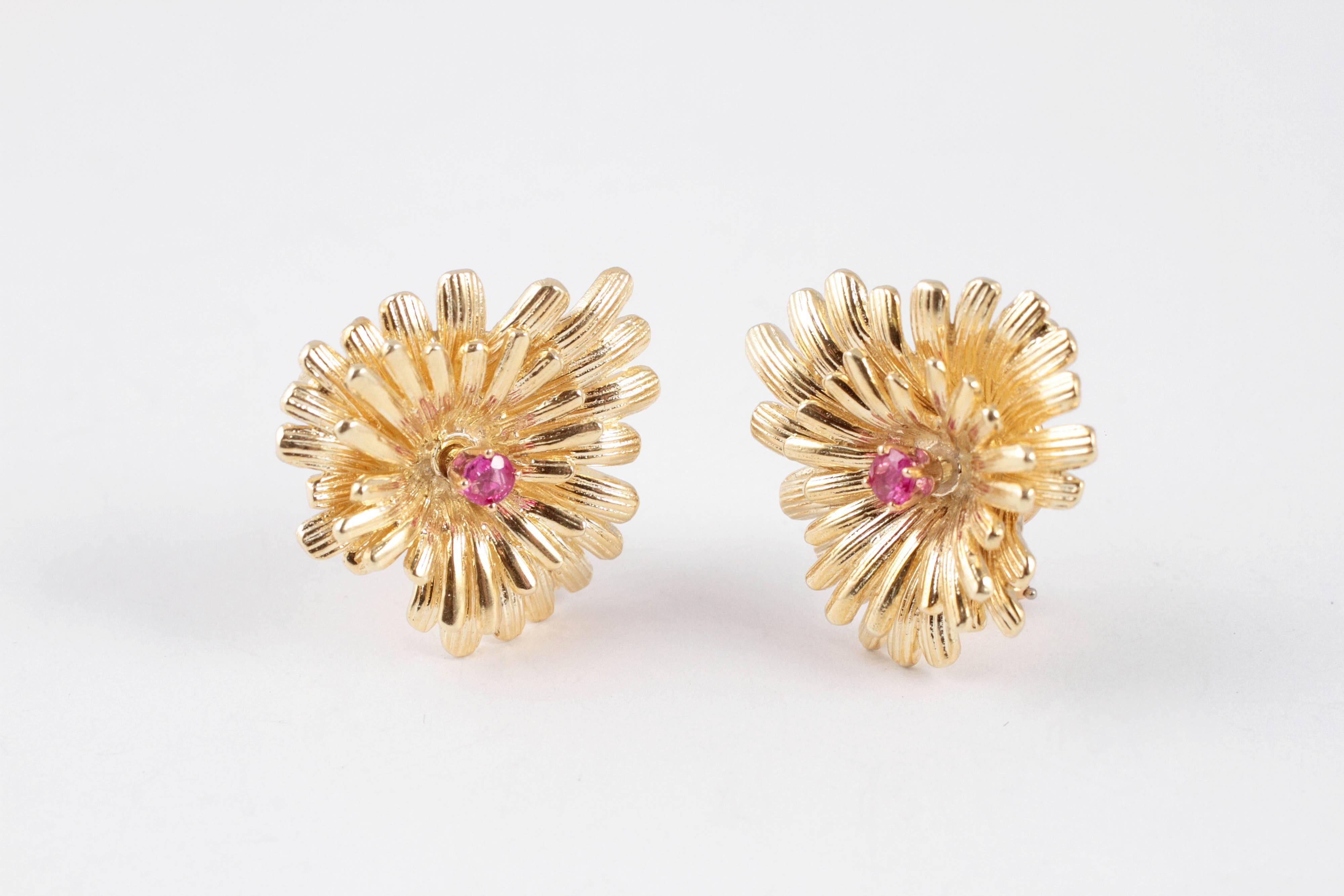 For the lover of all things classic!  These clip on earrings are composed of 14 karat yellow gold, in a flower shape, centered with one bright ruby.